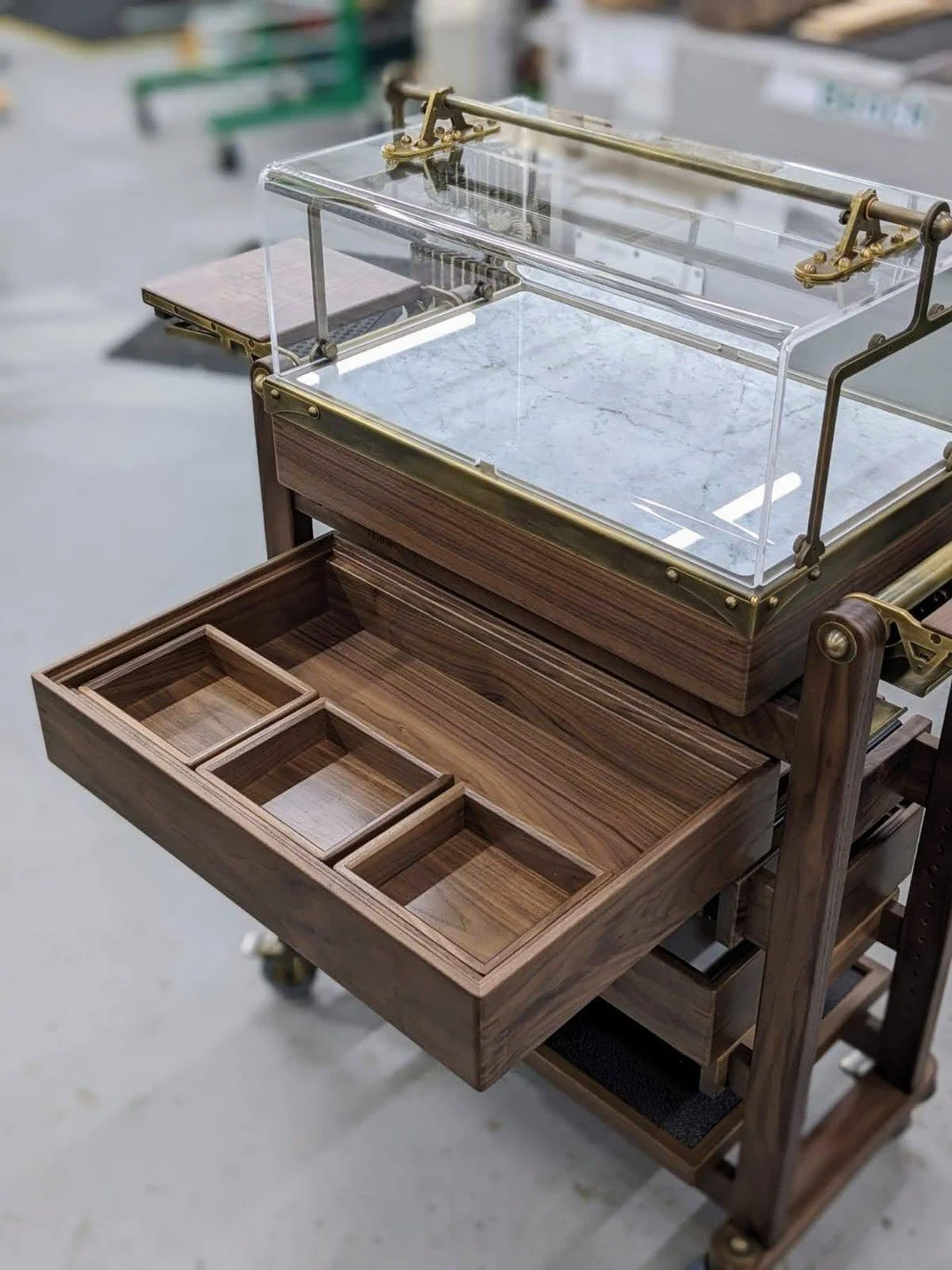 Remember the bon-bon boxes, drying in our workshop?

Here they are in-situ, nestled in the bespoke trolley we designed and built in our workshop using American walnut, Italian marble and antiqued brass. 

The trolley's boxes and trays can be accessed