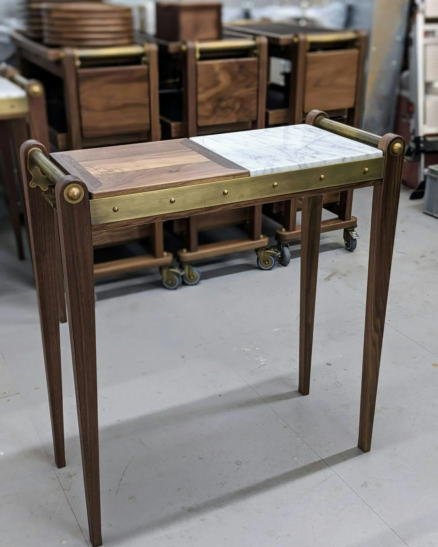 Inspired by our signature @rewthink trolley design, this fixed stand uses the same construction and detailing with the addition of elegant, tapered legs and antiqued brass metalwork.

The removable work surfaces are split 50/50 between prized Carrara