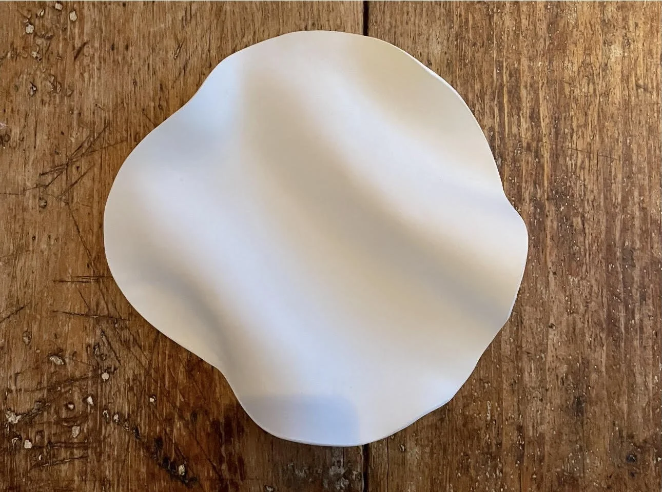 Sculptural plate 2024 . Clay . Hand-built . White gloss glaze . 14" x 12" . Sold