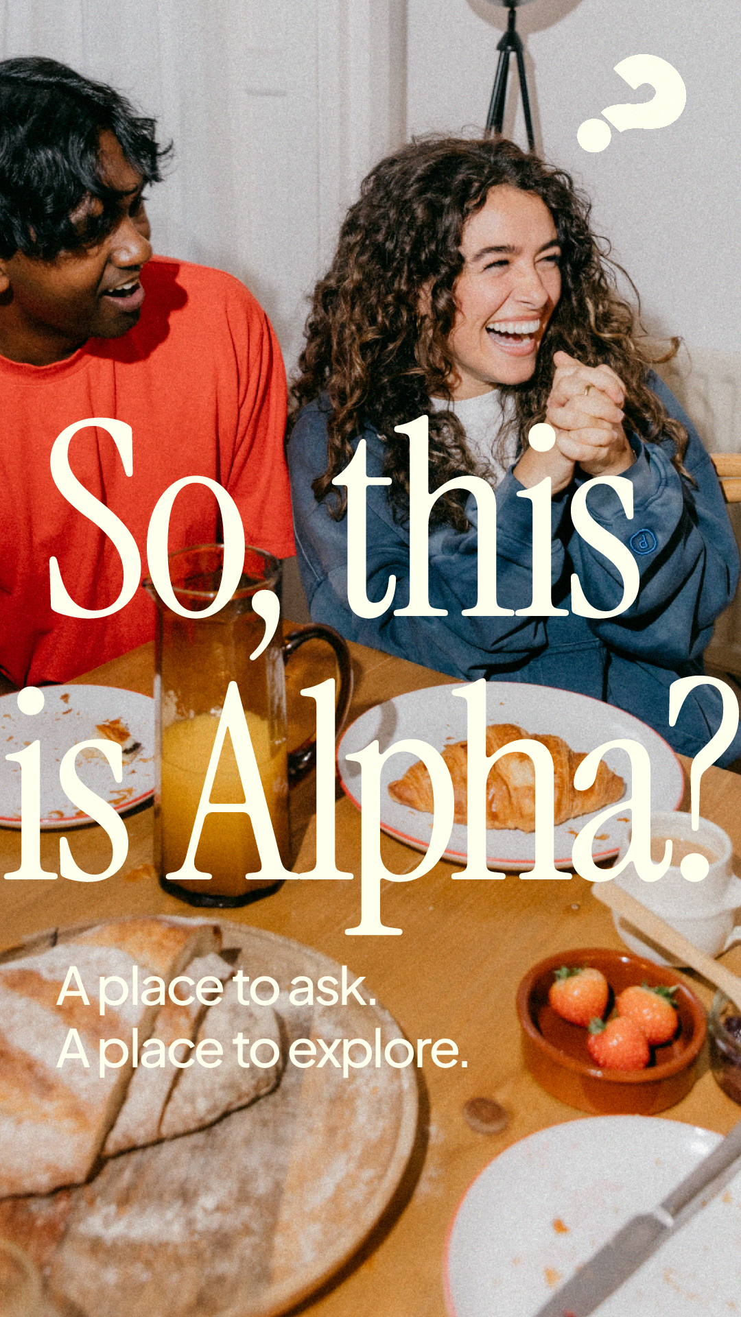 Two women sitting at a dining table with food, smiling and laughing. Text overlay says 'So, this is Alpha?' and 'A place to ask. A place to explore.'