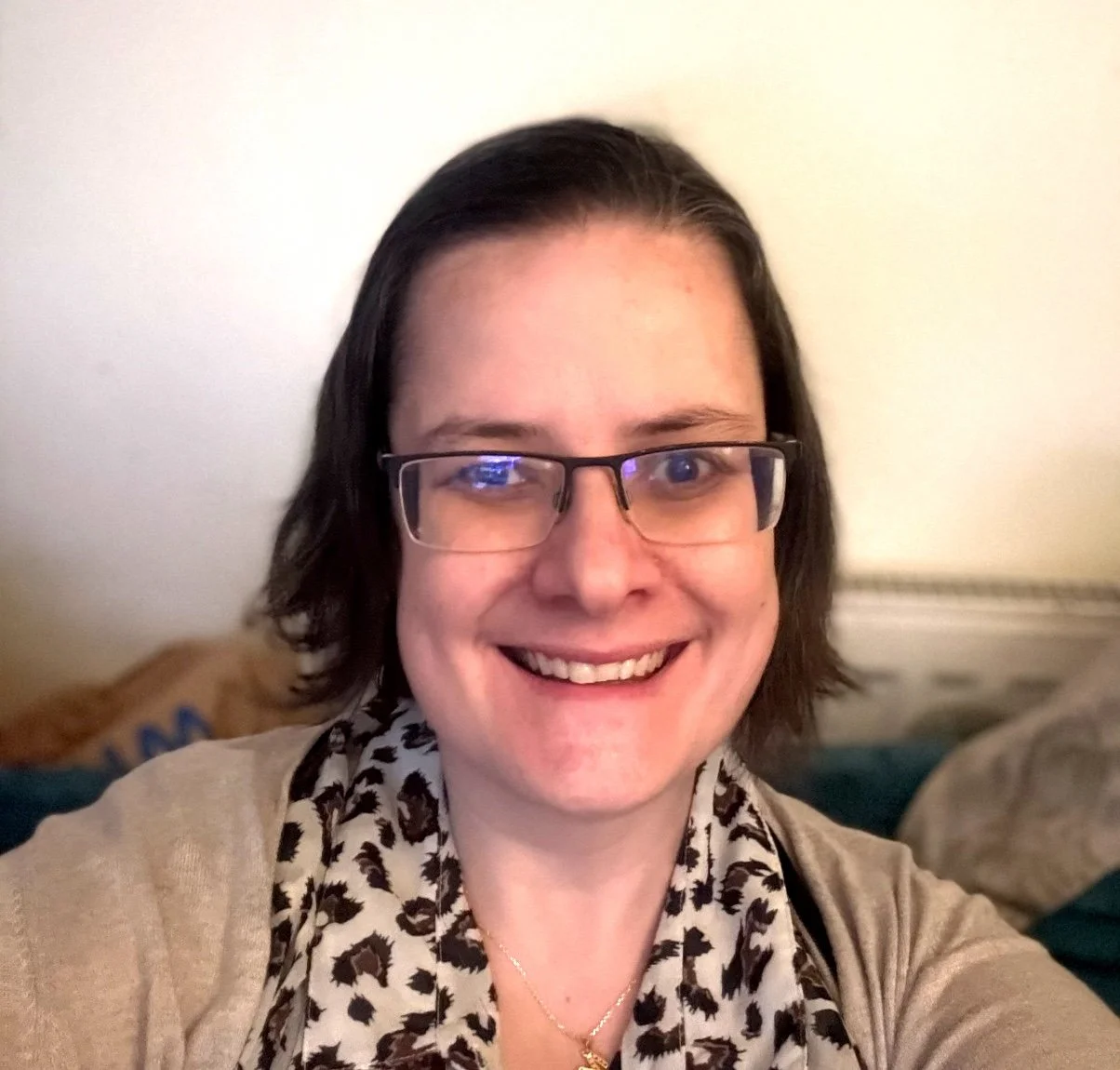 A woman with dark hair smiling at the camera