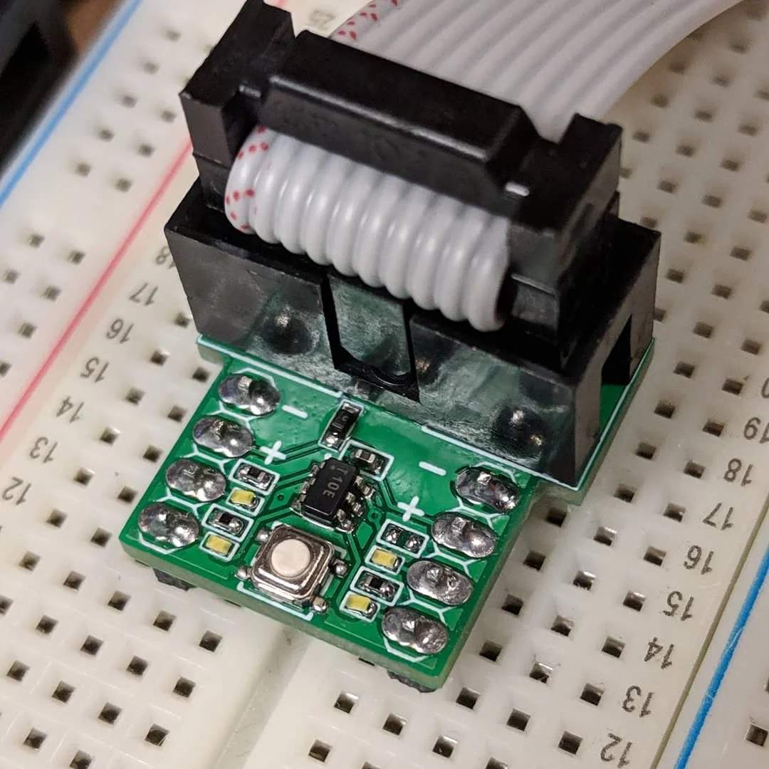 (2019) A dev board for the ATtiny 10 mcu. It features an IDC connector for easy connection to an Atmel ICE programmer.