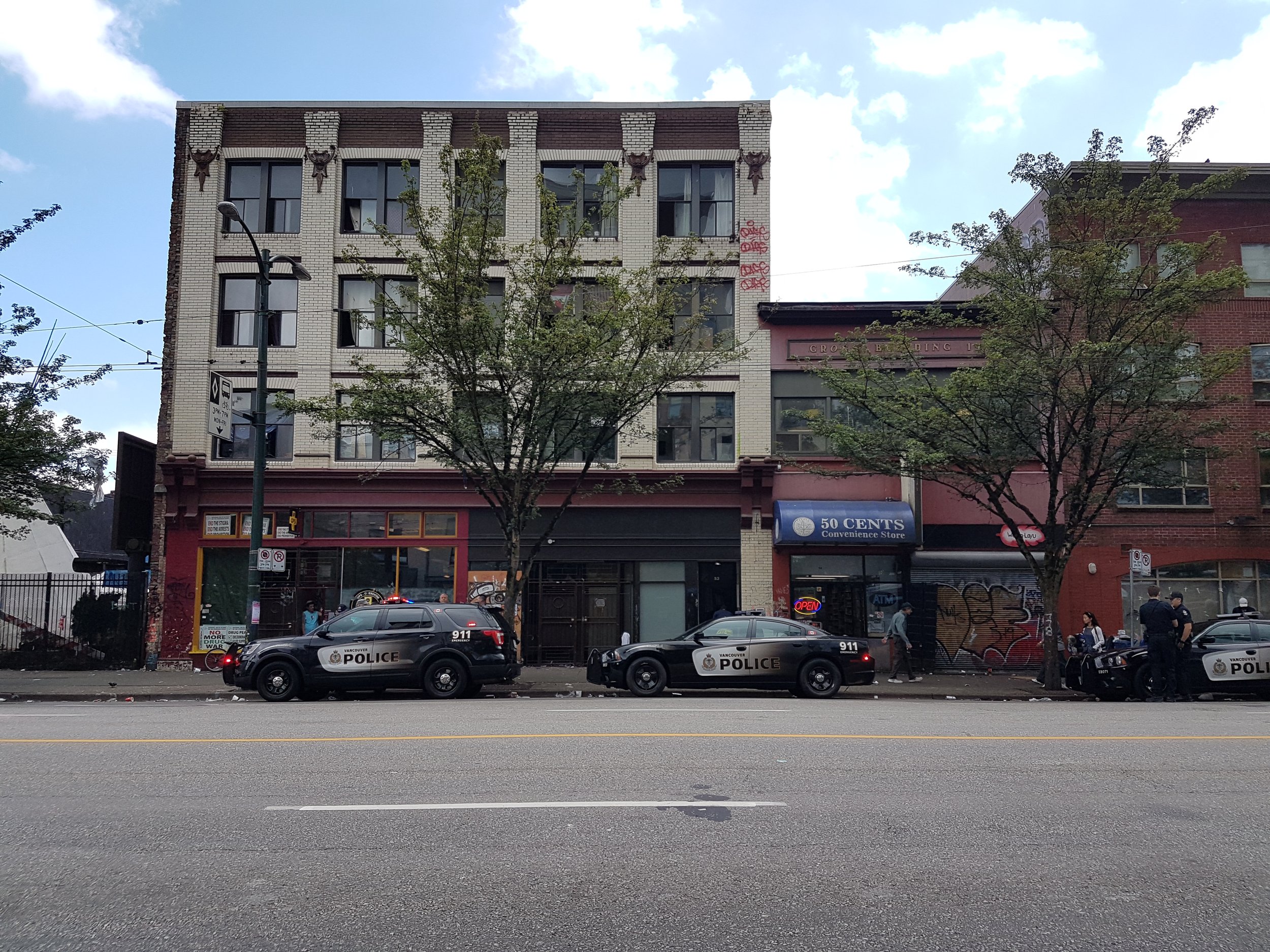  Three VPD vehicles parked outside the Vancouver Overdose Prevention Society on July 2, 2019. (Photo: Alexander Kim) 