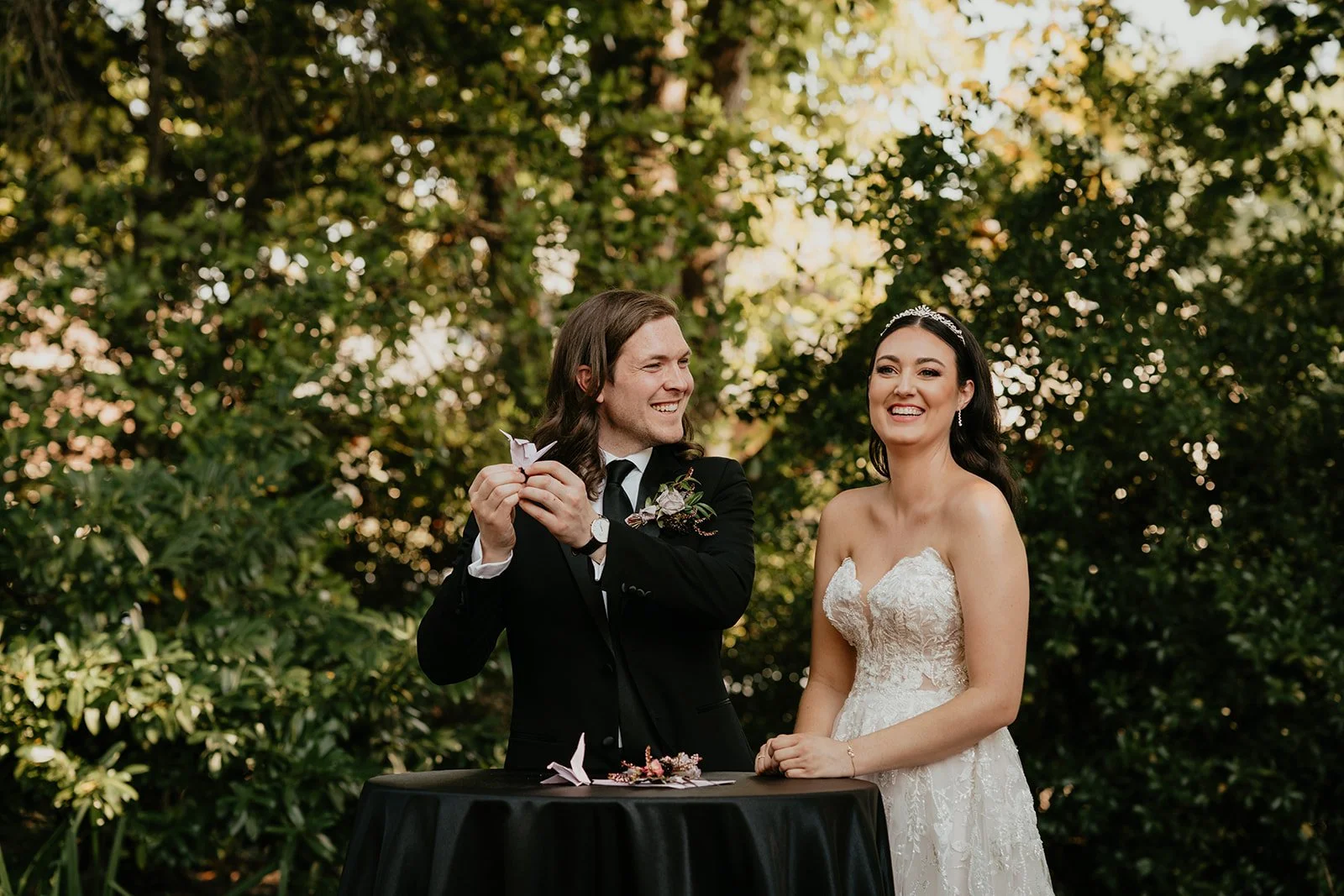 Bride and groom laughing while exchanging personal vows a unique unity ceremony at an outdoor Oregon wedding