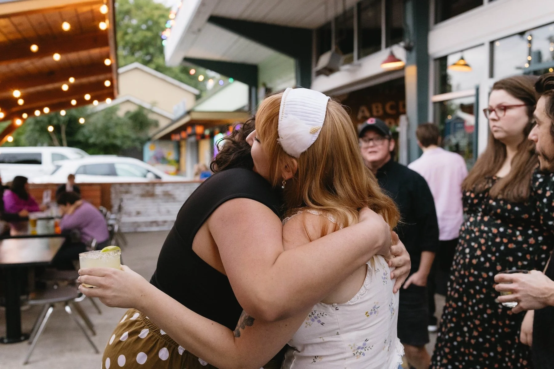 Friends reuniting at a casual outdoor welcome party in Portland Oregon