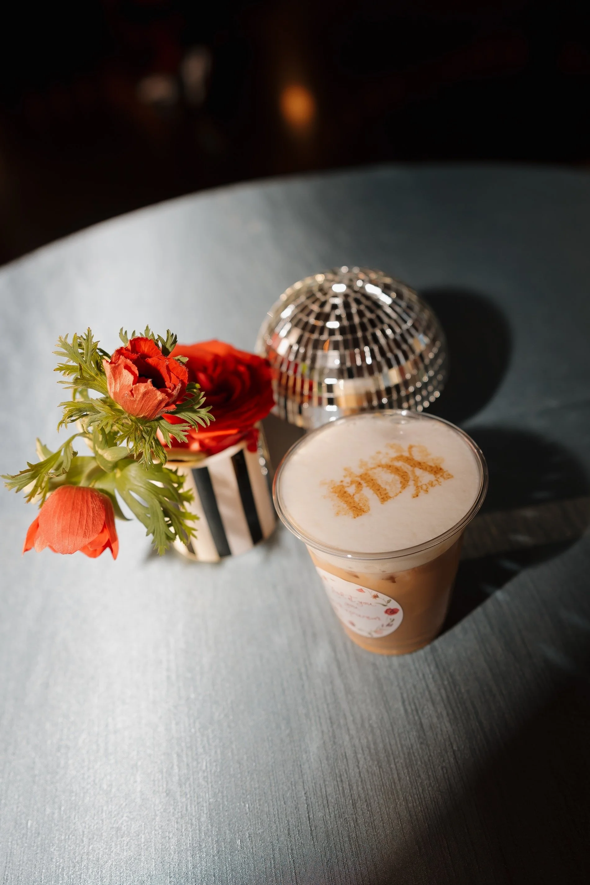 Custom monogrammed coffee drink and mini disco ball as part of a Portland wedding weekend welcome detail
