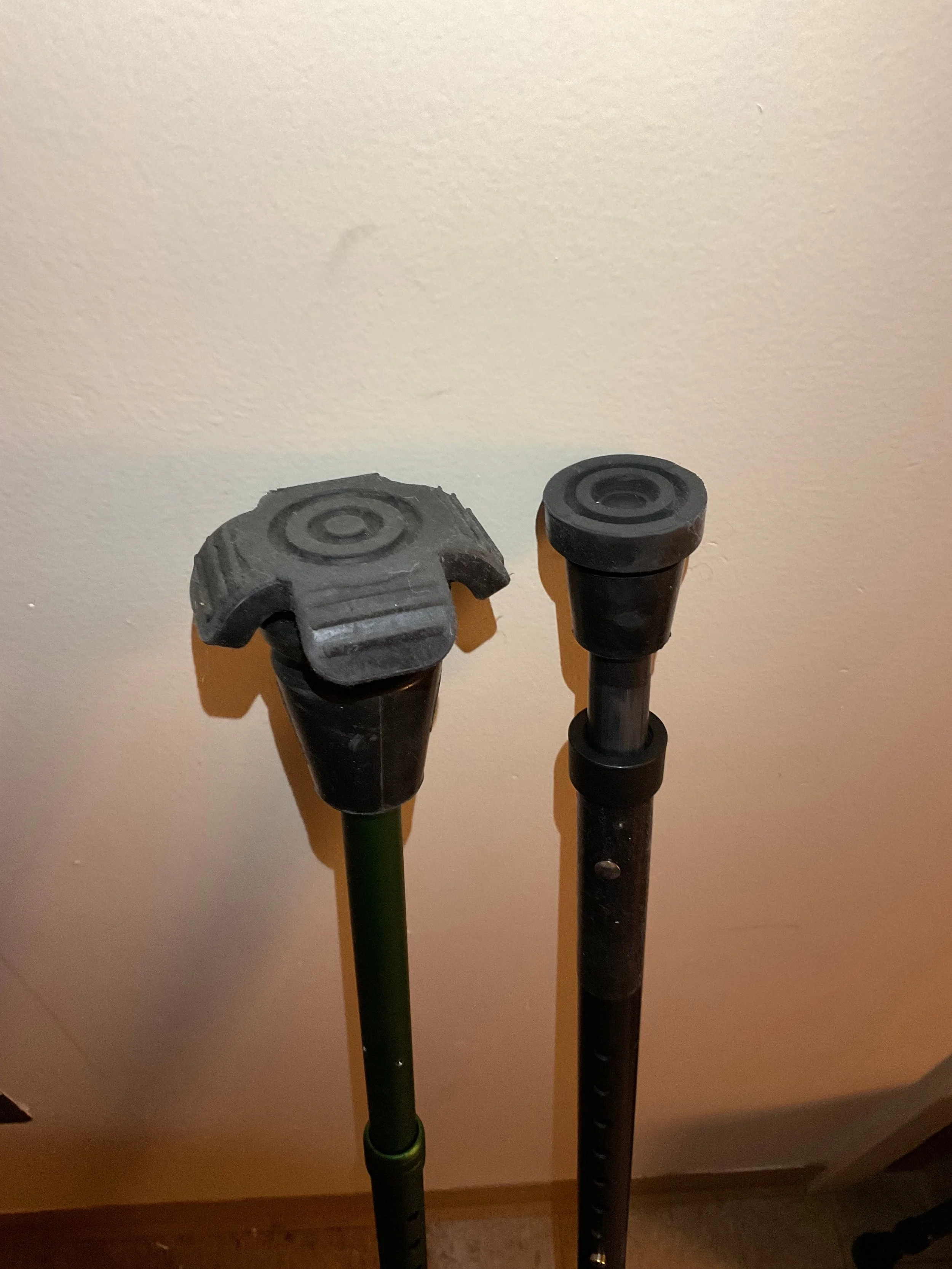 The crutch tips of the Ergoactives and Millenials. The Ergoactive tip is large, about 3 inches in diameter, with four angled wings coming out of it. The Millennial tip is a standard round crutch tip of about an inch and a half’s diameter.