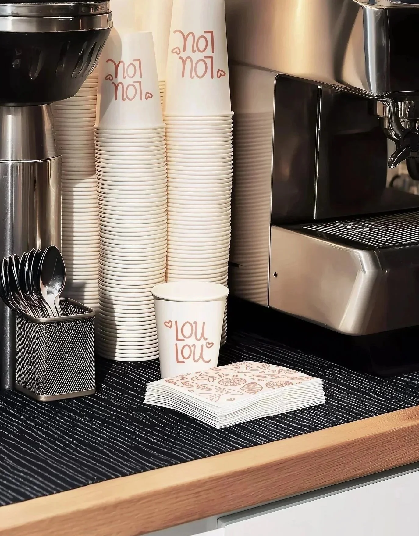 illustrated logo for a bakery concept, shown on paper coffee cups