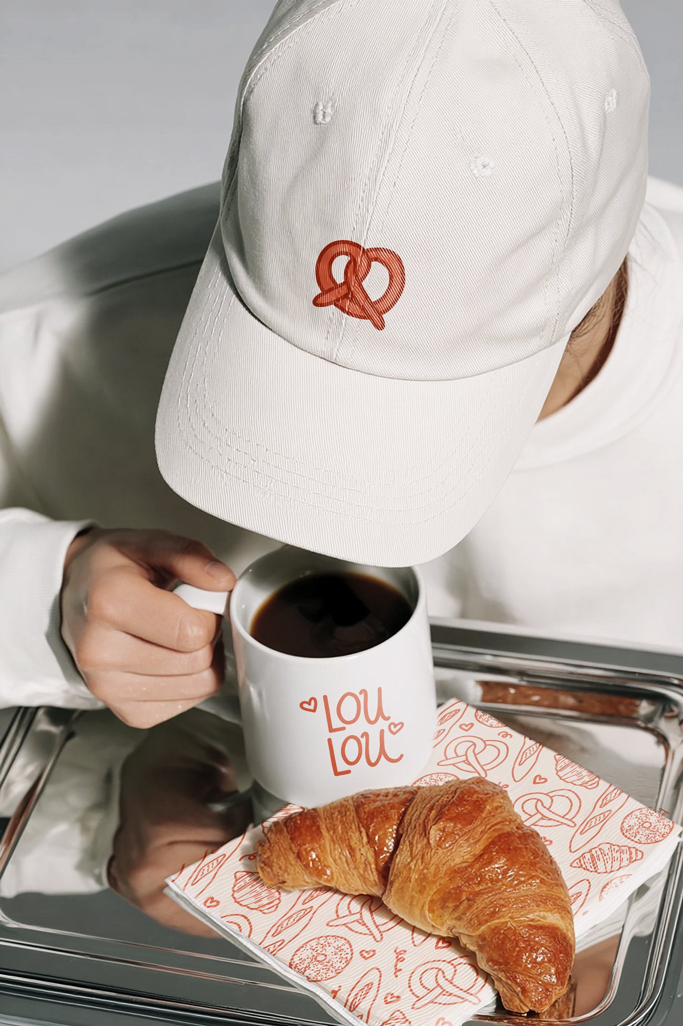 illustrated logo and icons for a bakery concept, shown on a mug and hat