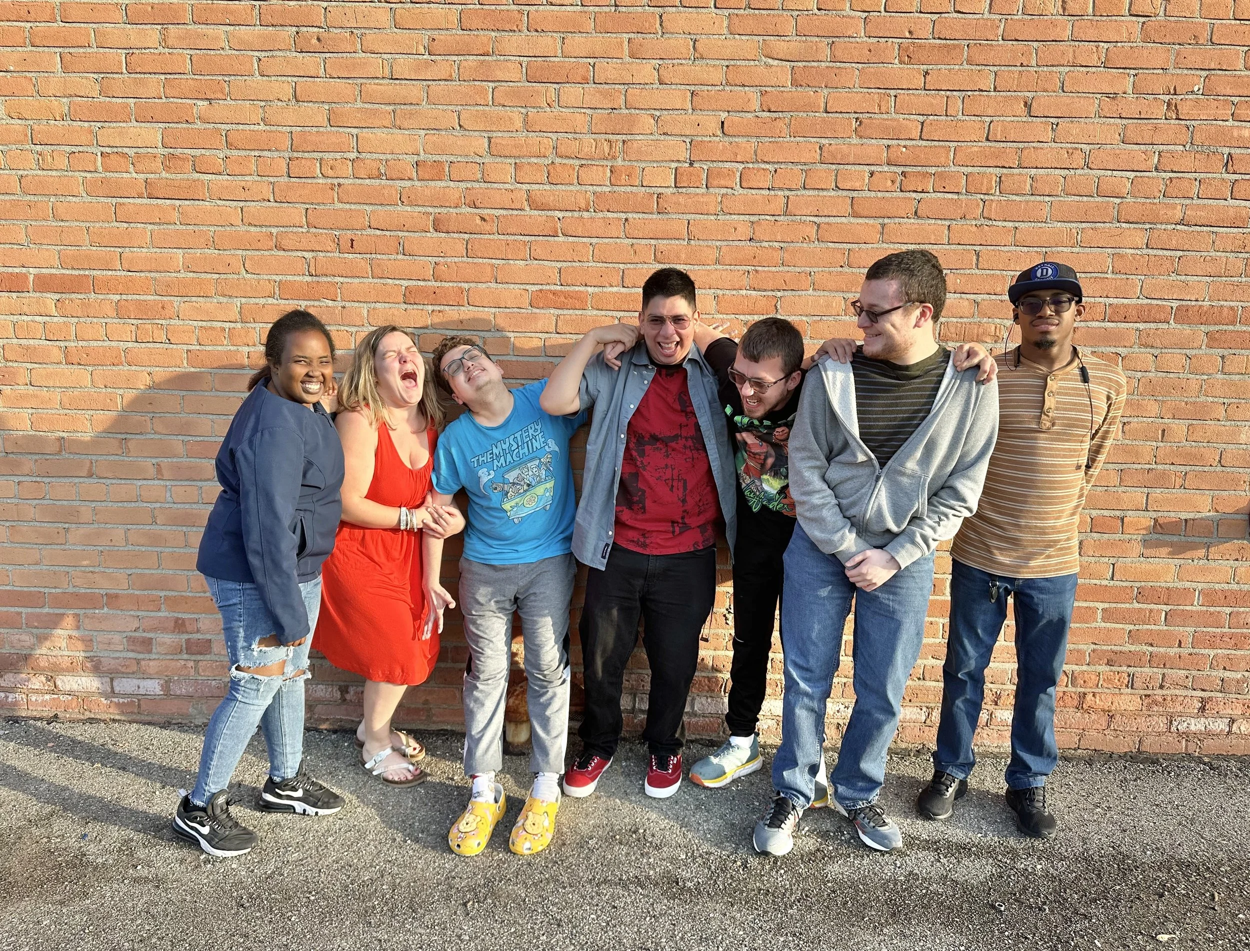 Group of seven diverse friends laughing and smiling in Berkley, MI, for Intellectual and Developmental Disabilities (IDD)