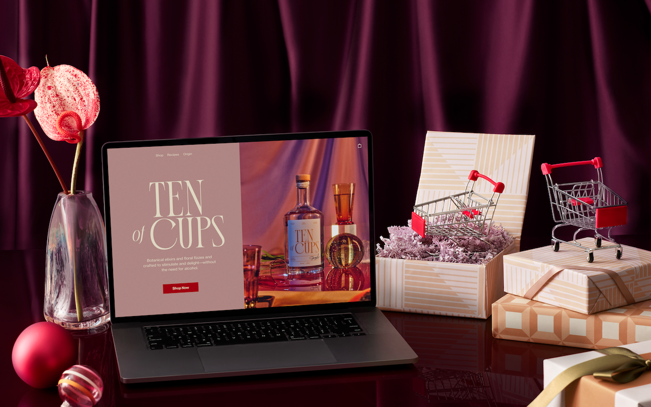laptop with microsite displayed with gift boxes containing small carts