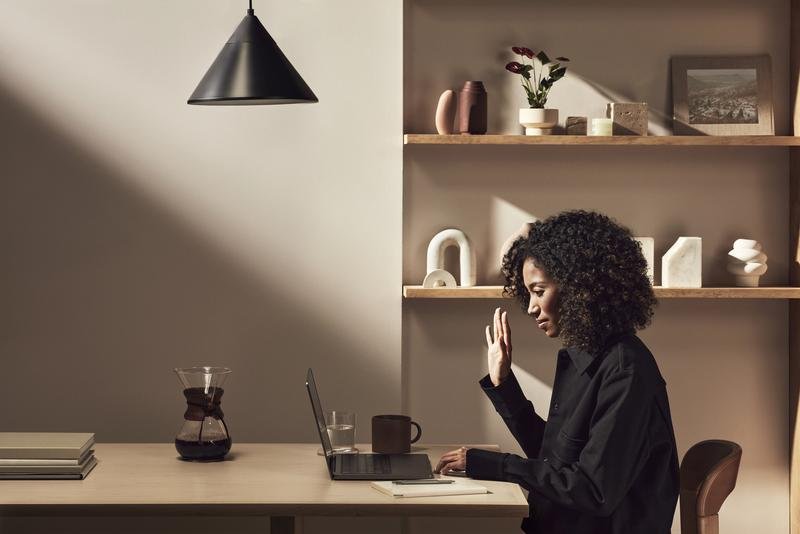 A Squarespace Enterprise account manager waving to her client on a video call