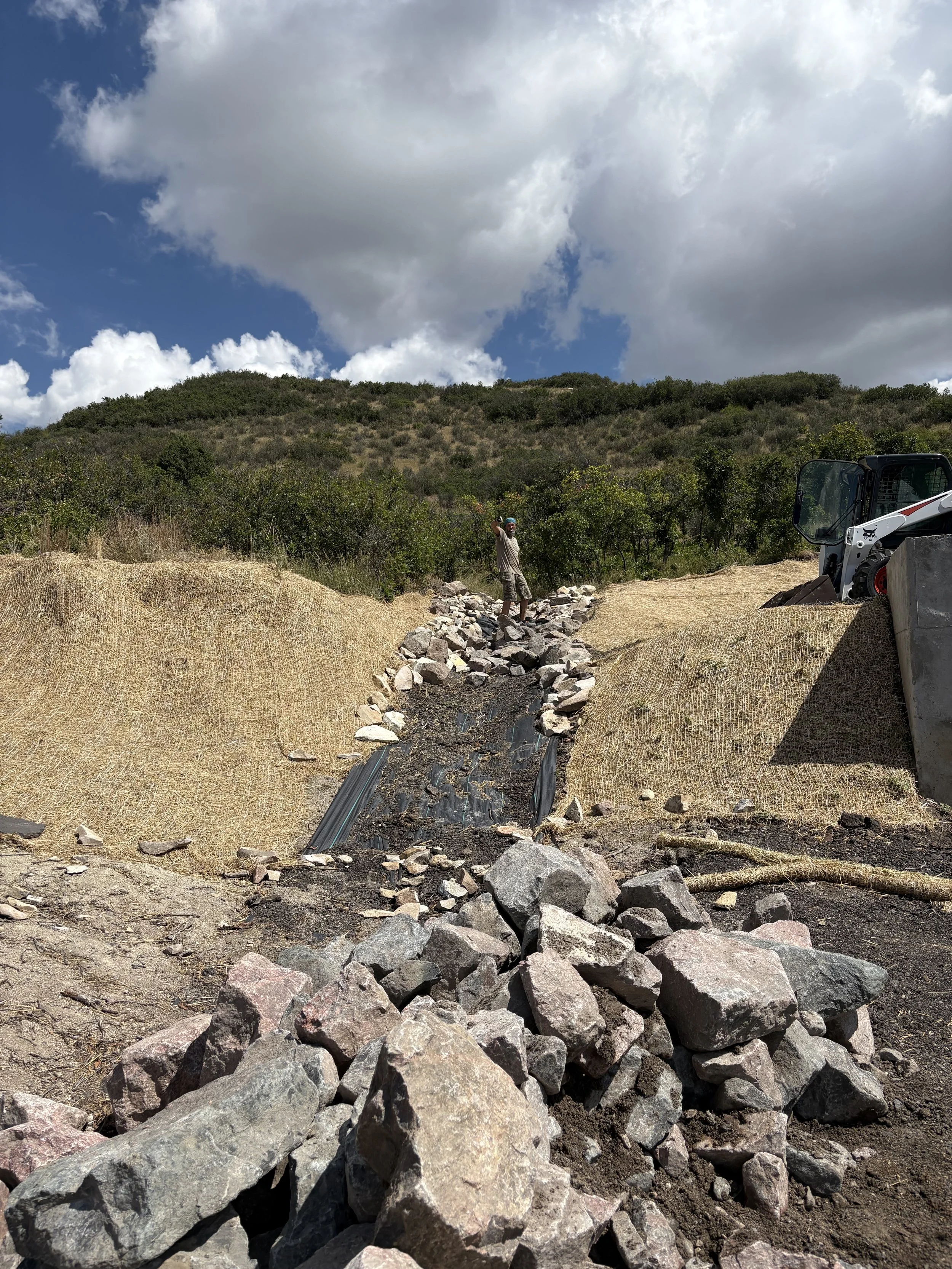Remember that dirt Kris was moving in the earlier photo gallery? This was why. A giant drainage ditch had to be built in the front of the house. 
