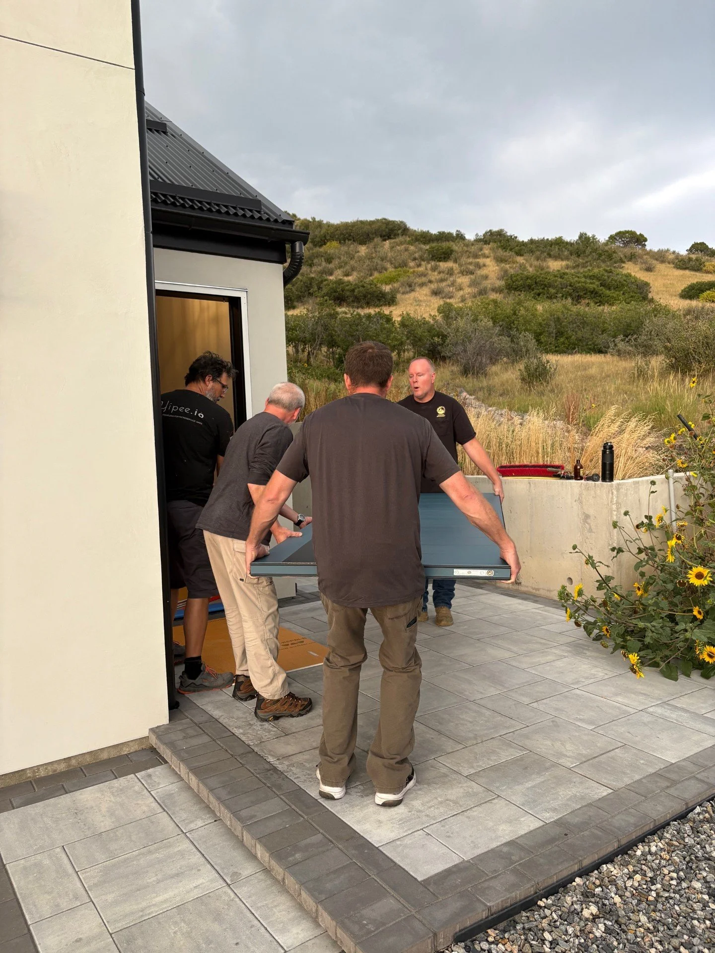 The guys line up and prepare to hoist it in.