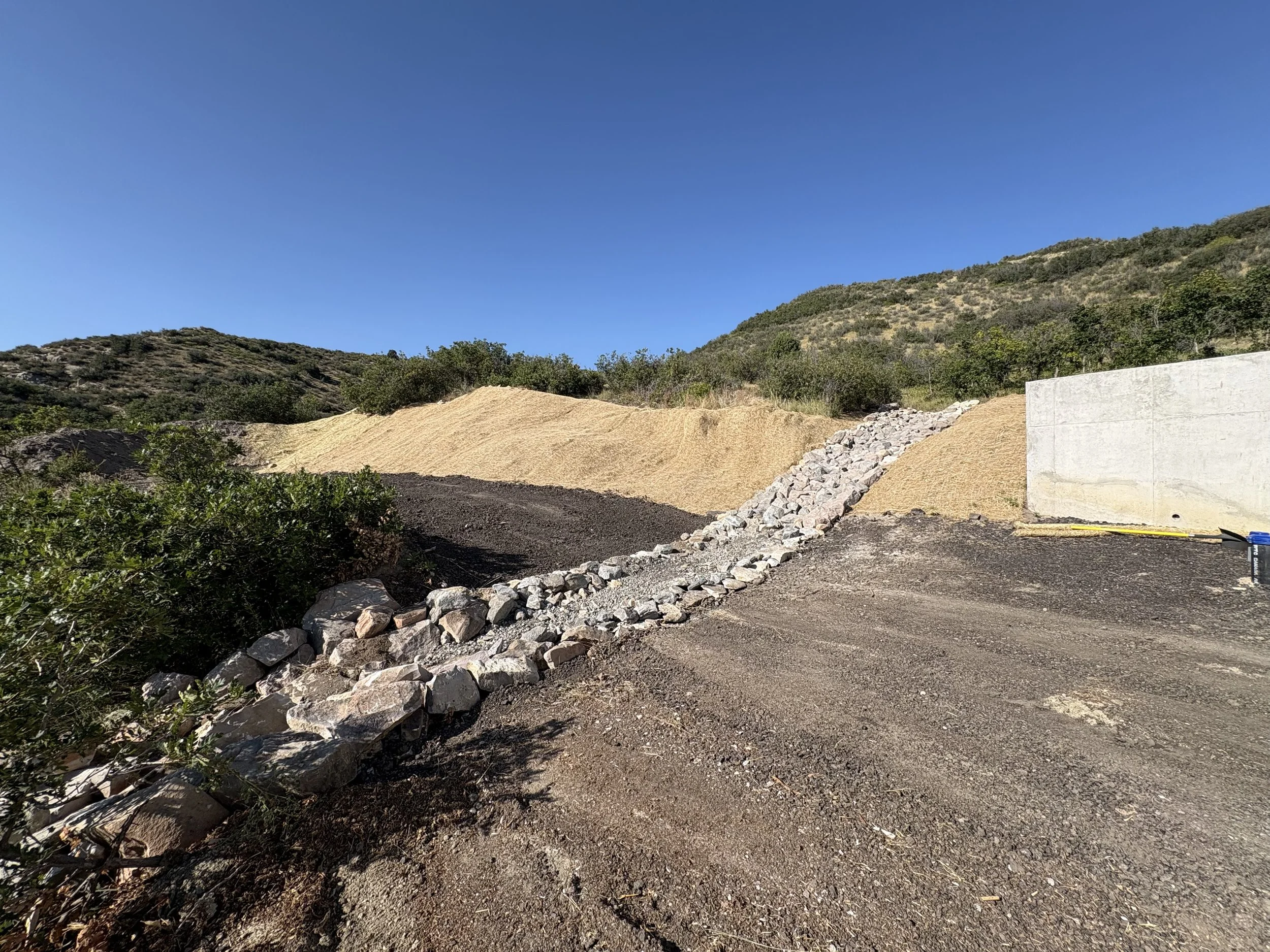 This section had to have a mix of rock sizes so the water would slow a bit before falling off the ravine side of our property.