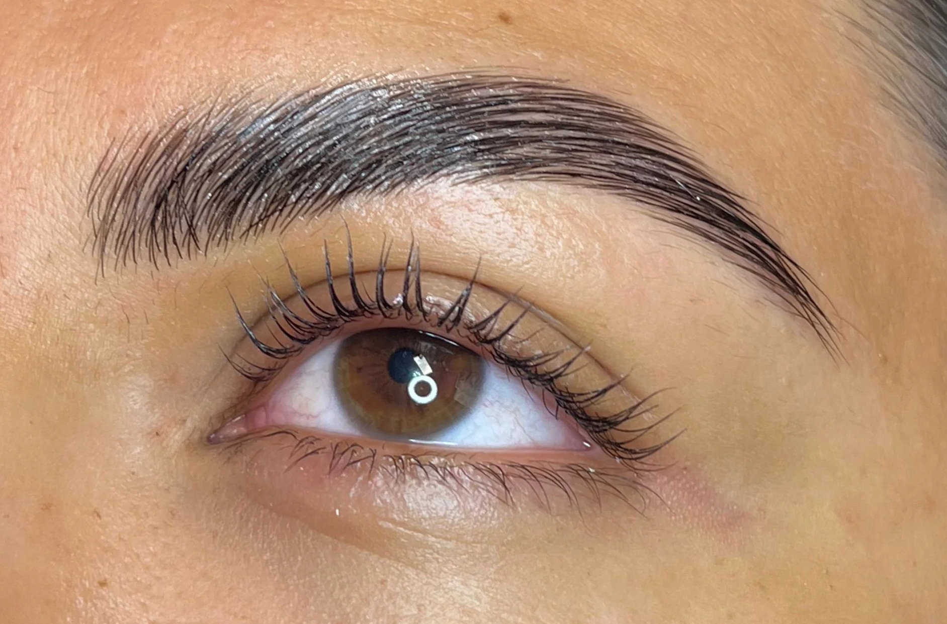 Close-up of a before and after brow lamination and tint.