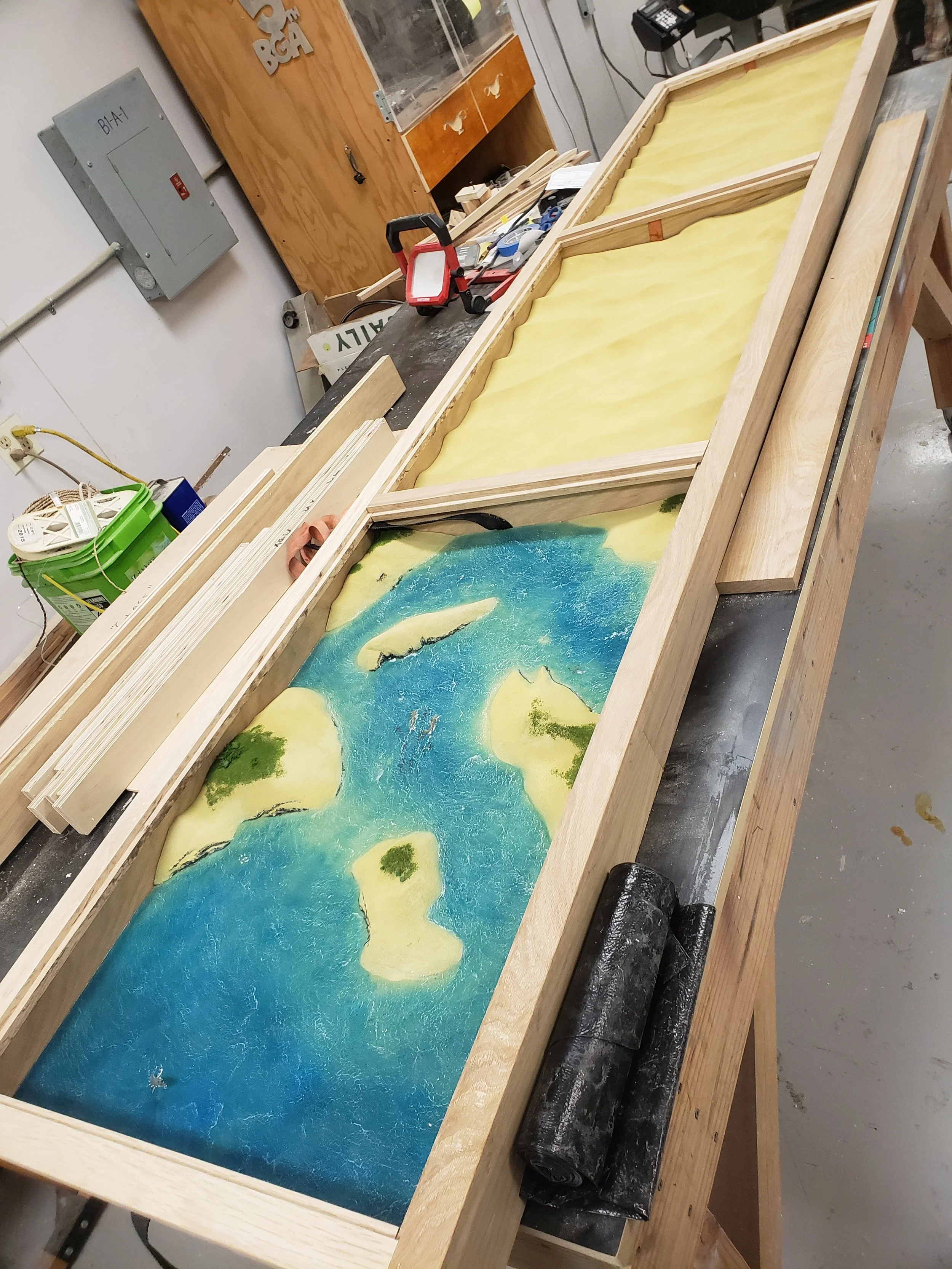 Table island diorama in progress. Carved from HDU, painted with acrylic and airbrush. Ocean made of resin, colored pencil