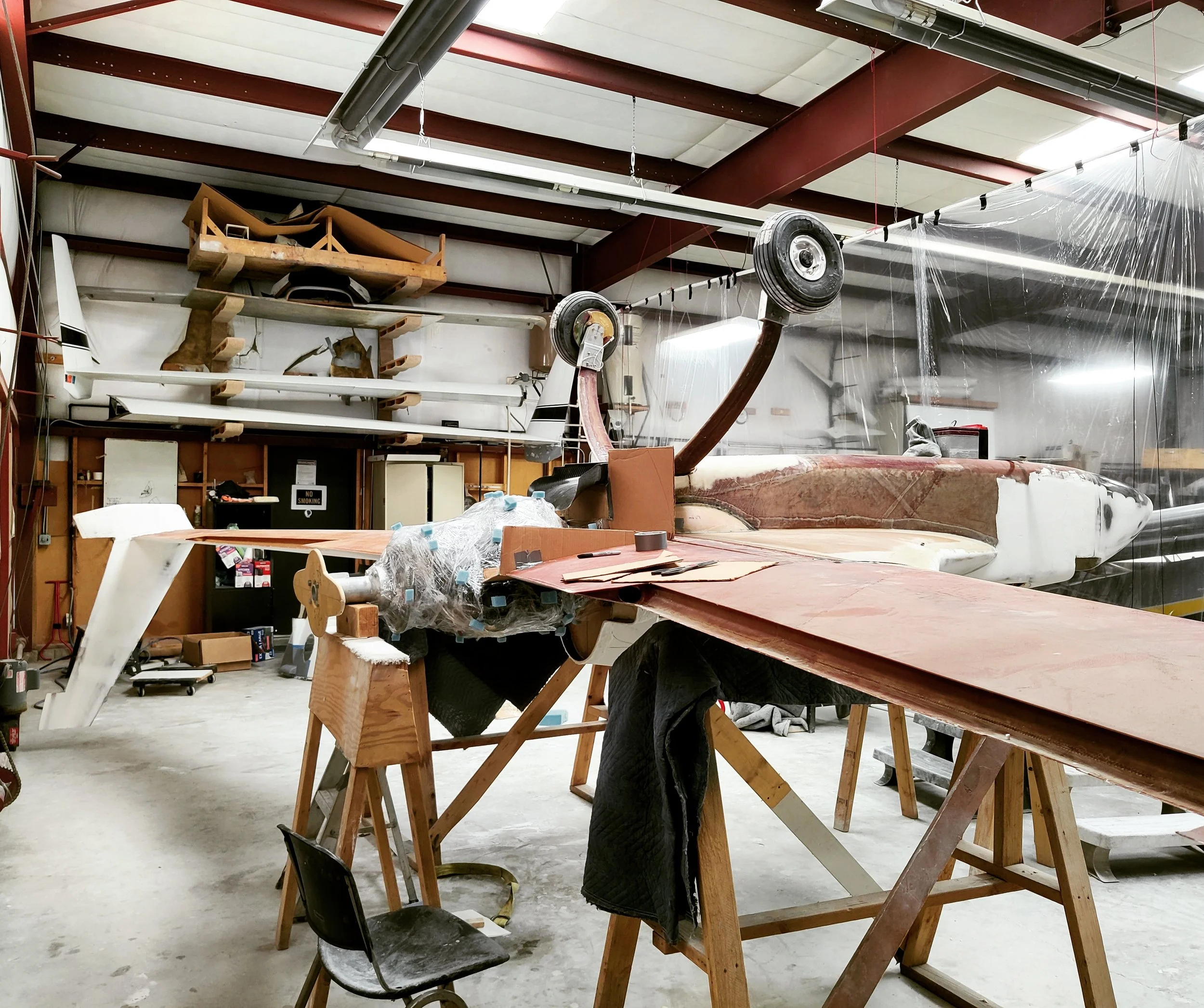 Long EZ on its back prepping the engine for a new bottom cowl