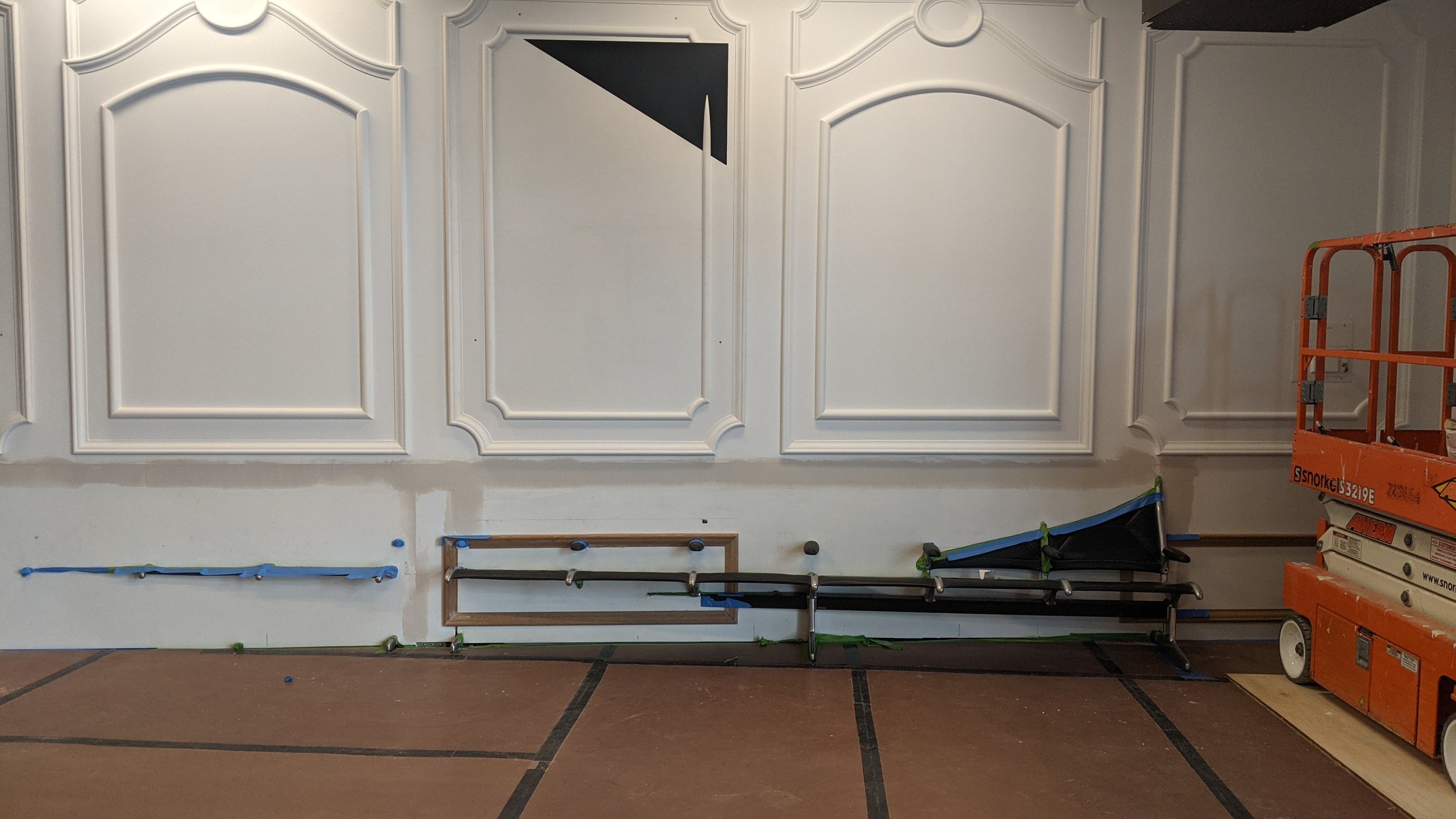 Beginning to install custom moulding around chairs onsite