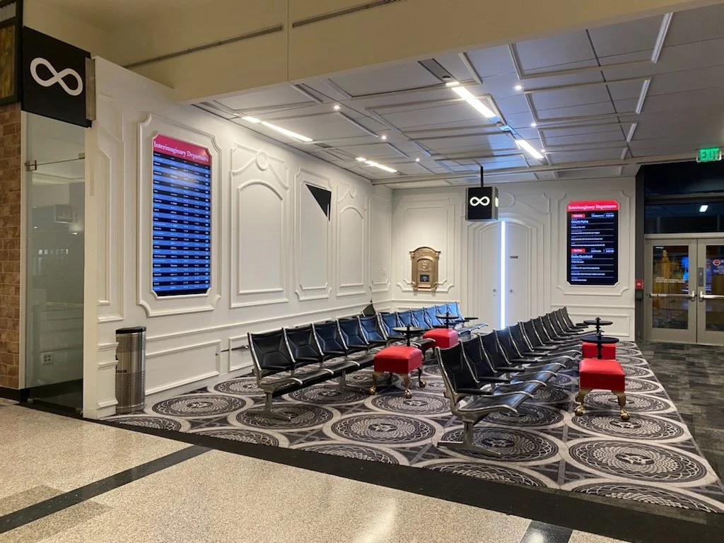 Final installation with custom ottomans intersecting airport benches
