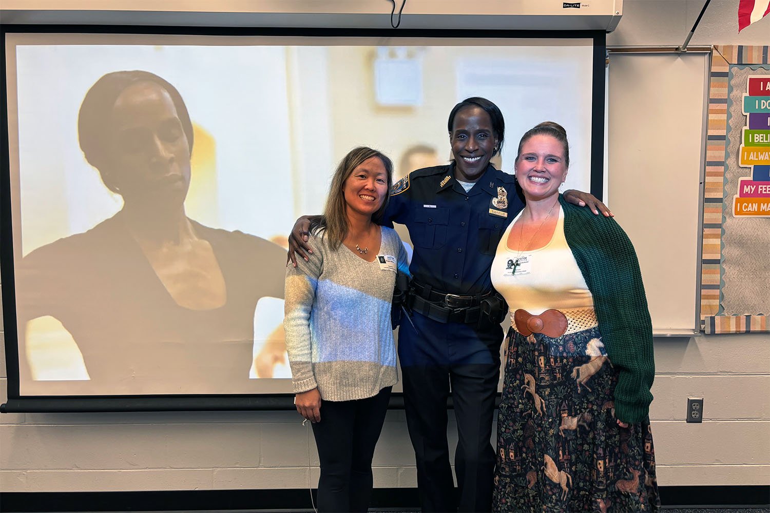 Retired NYPD officer posing with teachers in a 5th grade classroom at Lacoochee Elementary School in Dade City, Florida