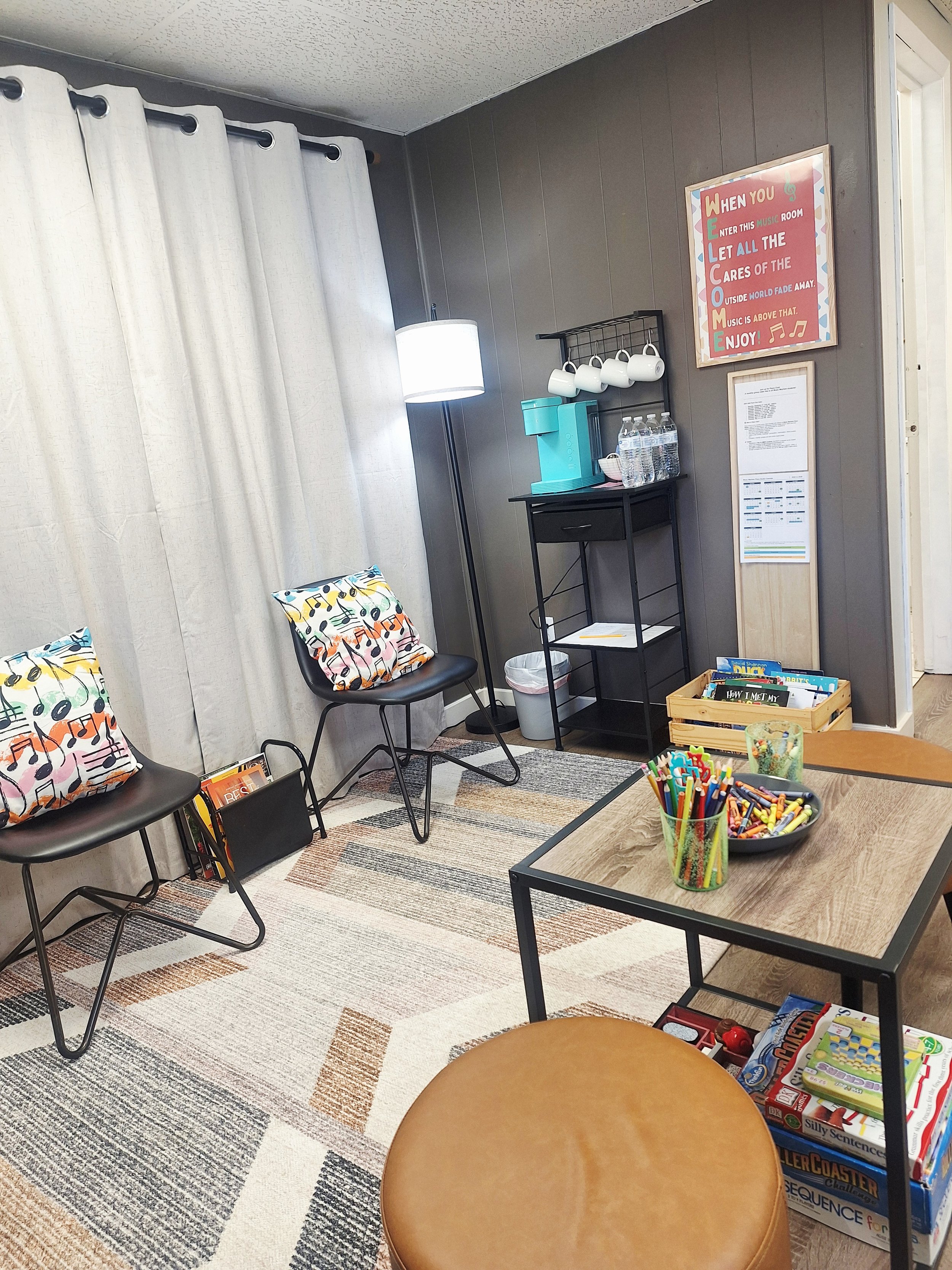 Clean and cozy waiting area with books, games, and free beverages.