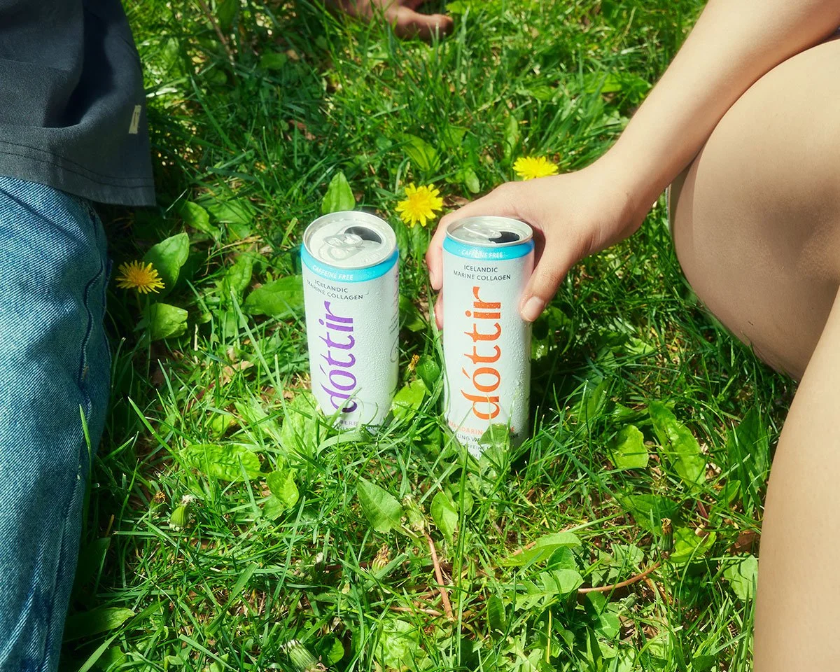 Dóttir collagen wellness drinks placed in green grass during the Spring into Summer product photography campaign by NAJ Captured.