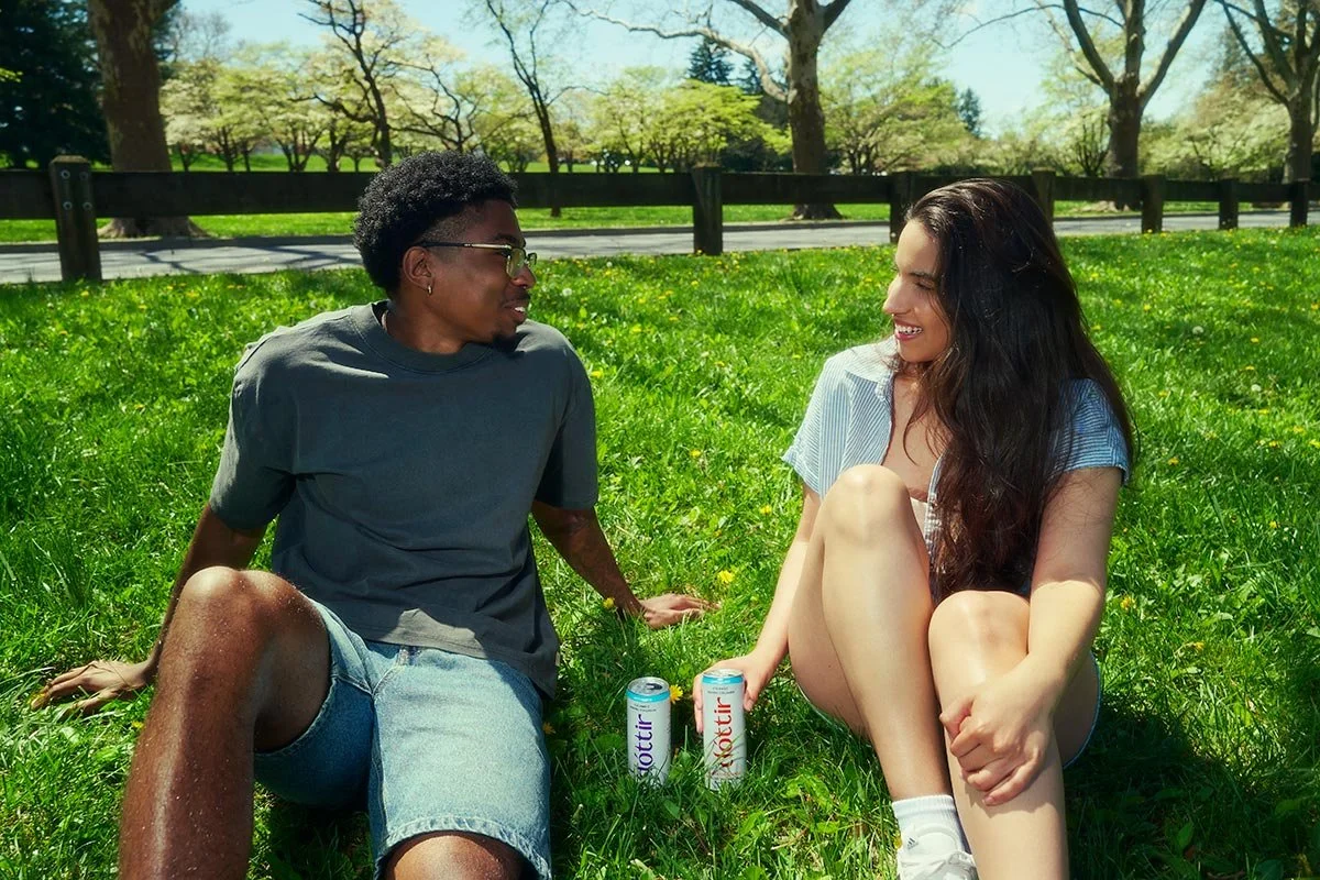 Young adults relaxing outdoors with Dóttir collagen wellness drinks during the Spring into Summer lifestyle beverage campaign photographed by NAJ Captured.