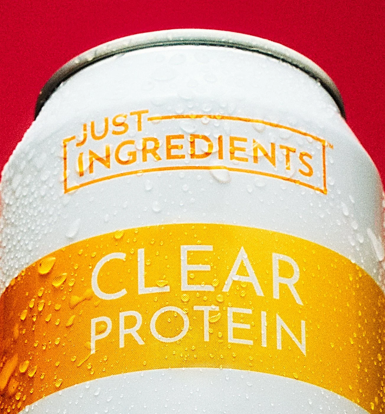 Close-up by NAJ Captured of the Just Ingredients logo and Clear Protein label on a chilled beverage can.