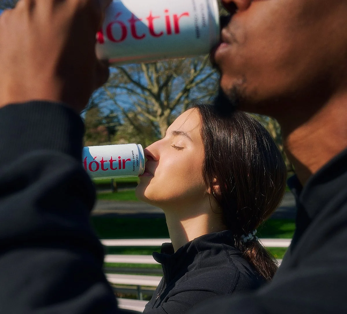 Two athletes enjoying Dóttir collagen wellness drinks outdoors during the Spring into Summer lifestyle drink campaign photographed by NAJ Captured