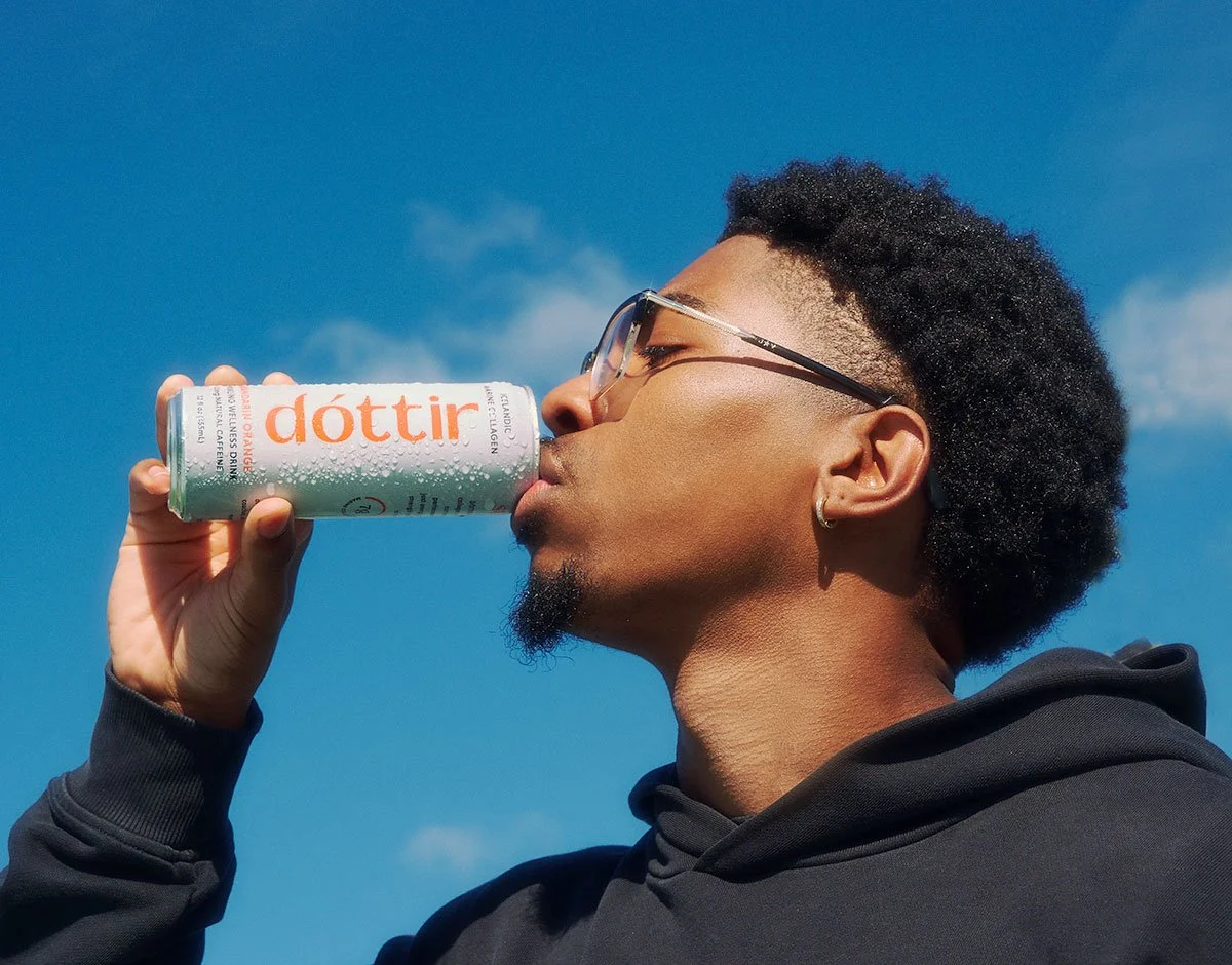 Athlete drinking a Dóttir Mandarin Orange collagen wellness drink during the Spring into Summer health and wellness campaign by NAJ Captured.