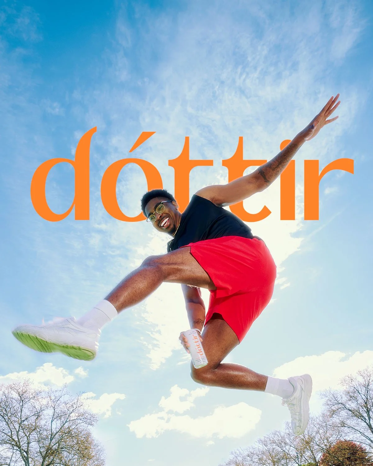 Athlete jumping while holding a Dóttir collagen wellness drink during the Spring into Summer fitness and wellness campaign by NAJ Captured.