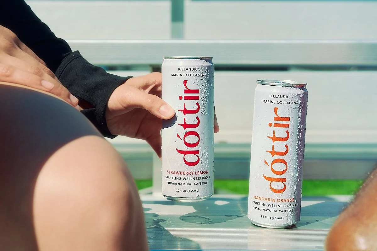 Dóttir collagen wellness drinks displayed on outdoor bleachers featuring natural caffeine, zero sugar, and zero artificial ingredients, photographed by NAJ Captured.