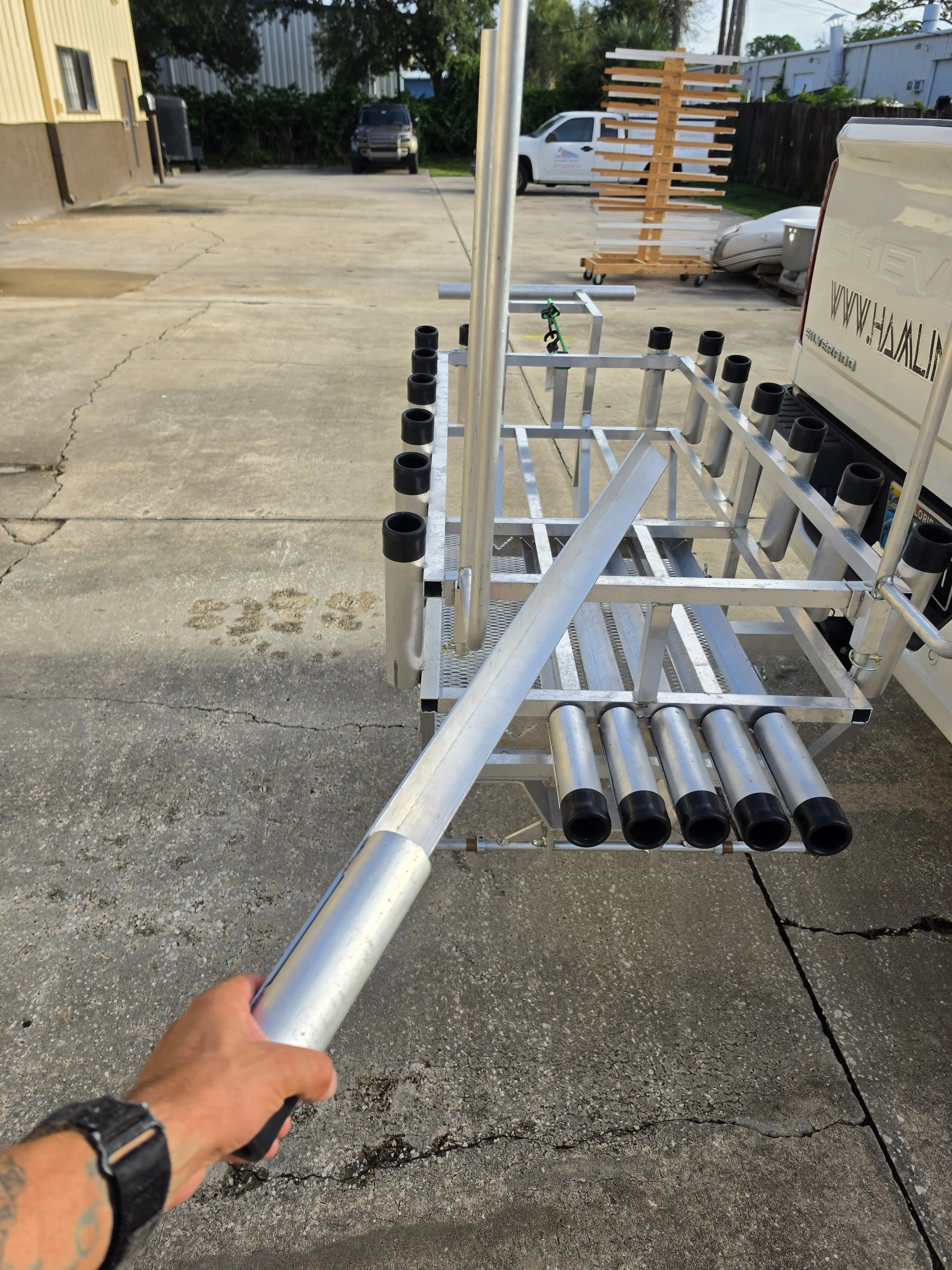 Angled sand spike storage rack on a custom beach fishing cart