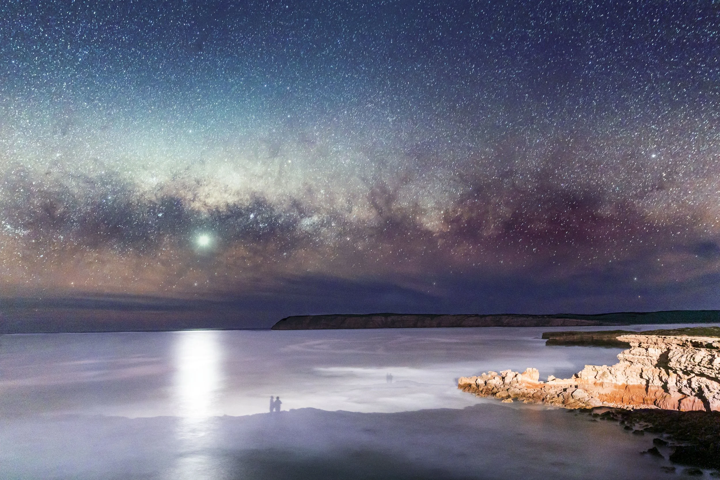 The Milky Way over shadows on the water cast from the lights of Venus Bay, South Australia
