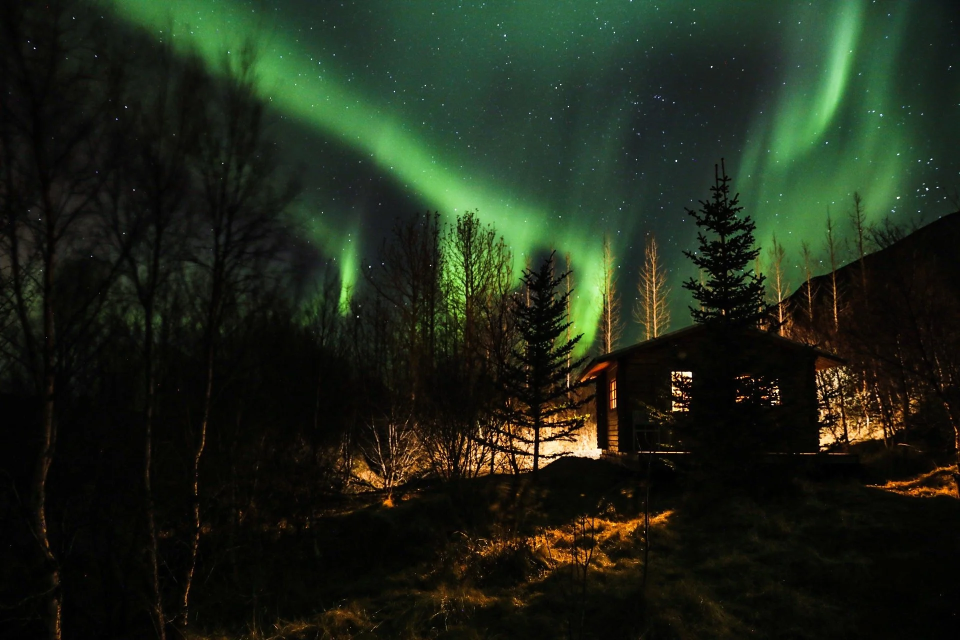 A cabin under the Northern Lights. Flúðir, Iceland