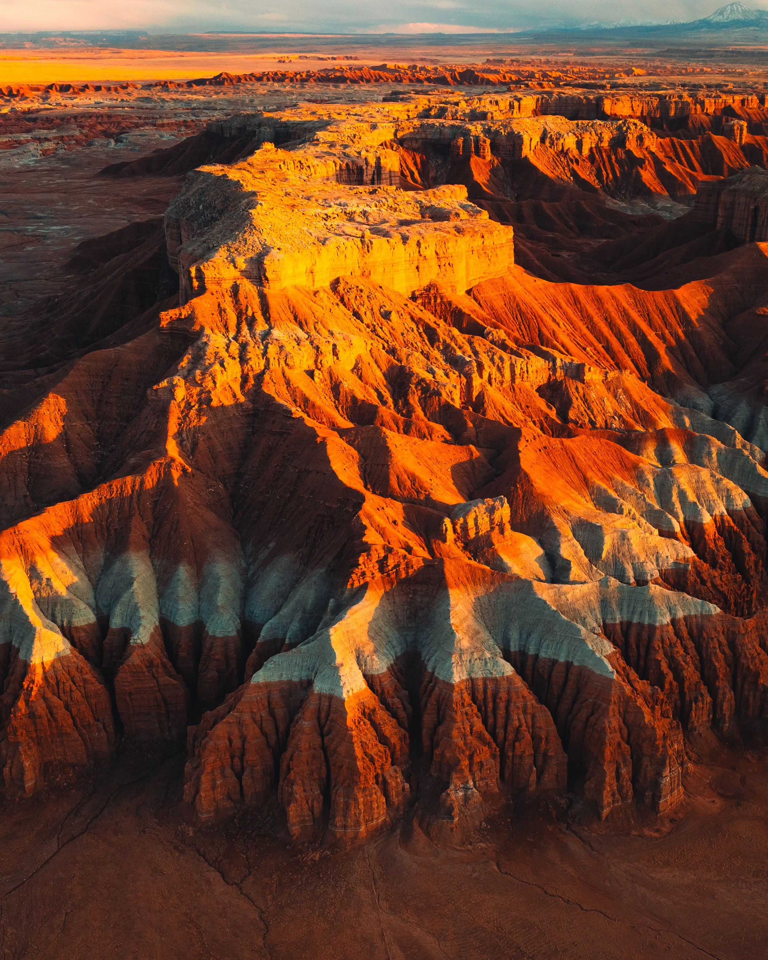 Sunset view of the Grand Canyon with vibrant orange, red, and gray layered rock formations.