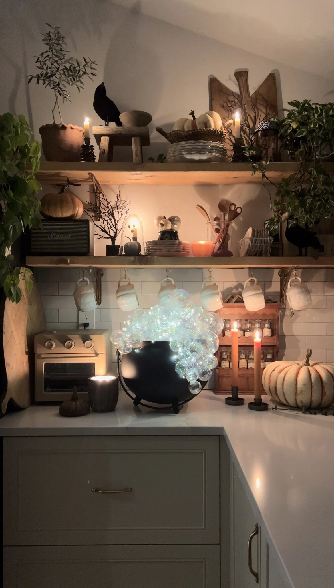 Day and evening views of a glowing cauldron on a kitchen counter