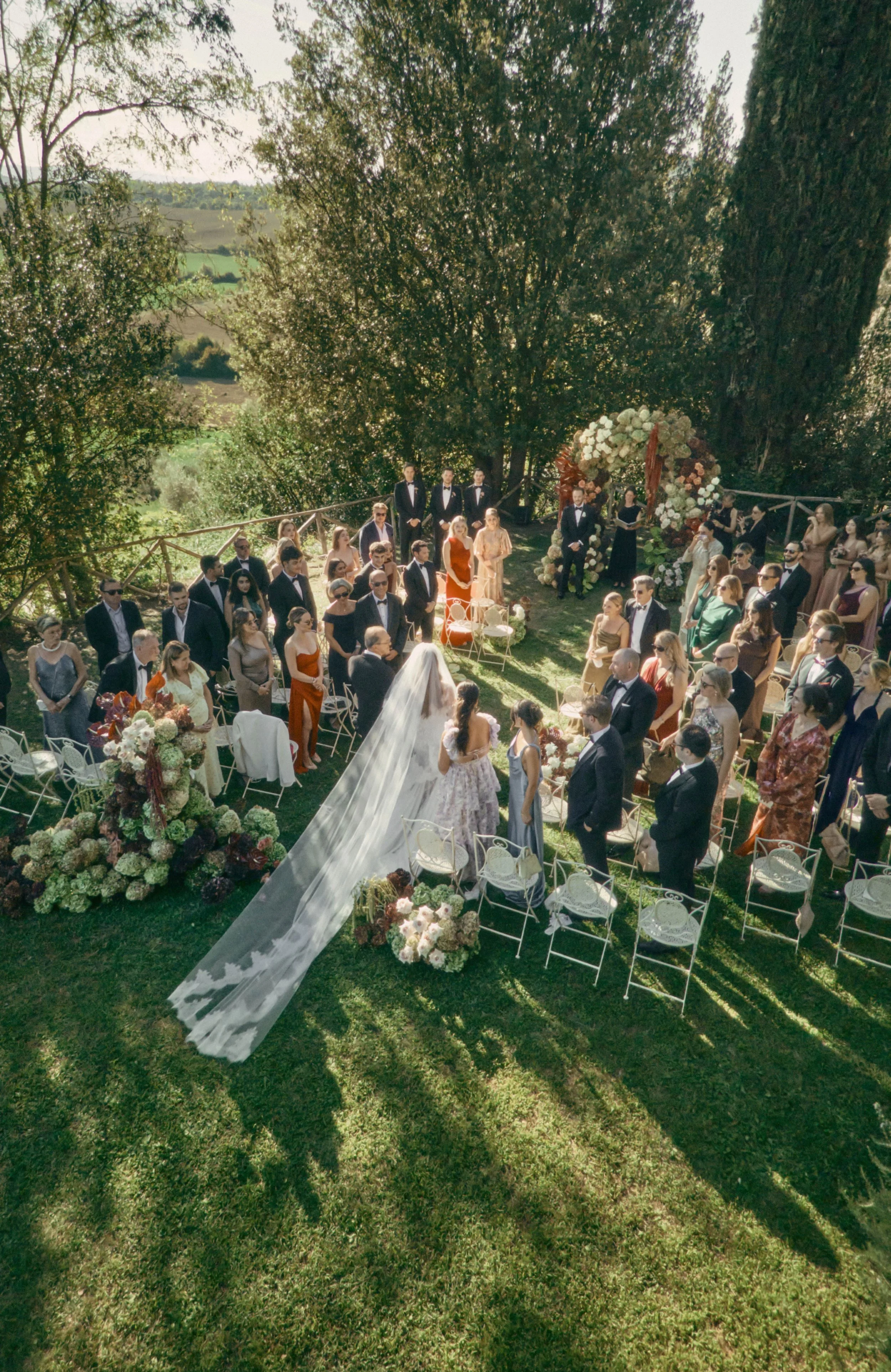Bride walking down the aisle on a garden in Tuscany