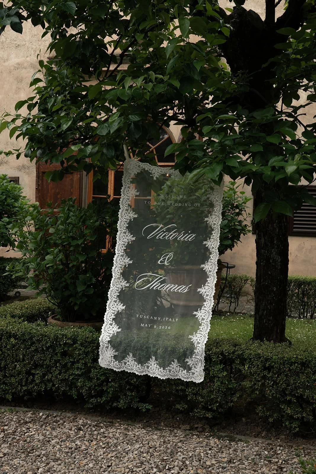 Elegant lace wedding welcome sign with delicate details at Villa Medicea di Lilliano, setting the tone for a romantic destination wedding in Florence, Italy.