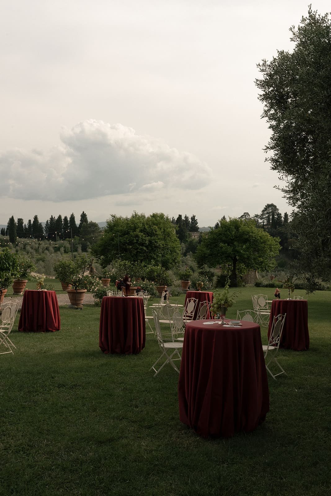Wedding cocktail tables with burgundy tablecloth 