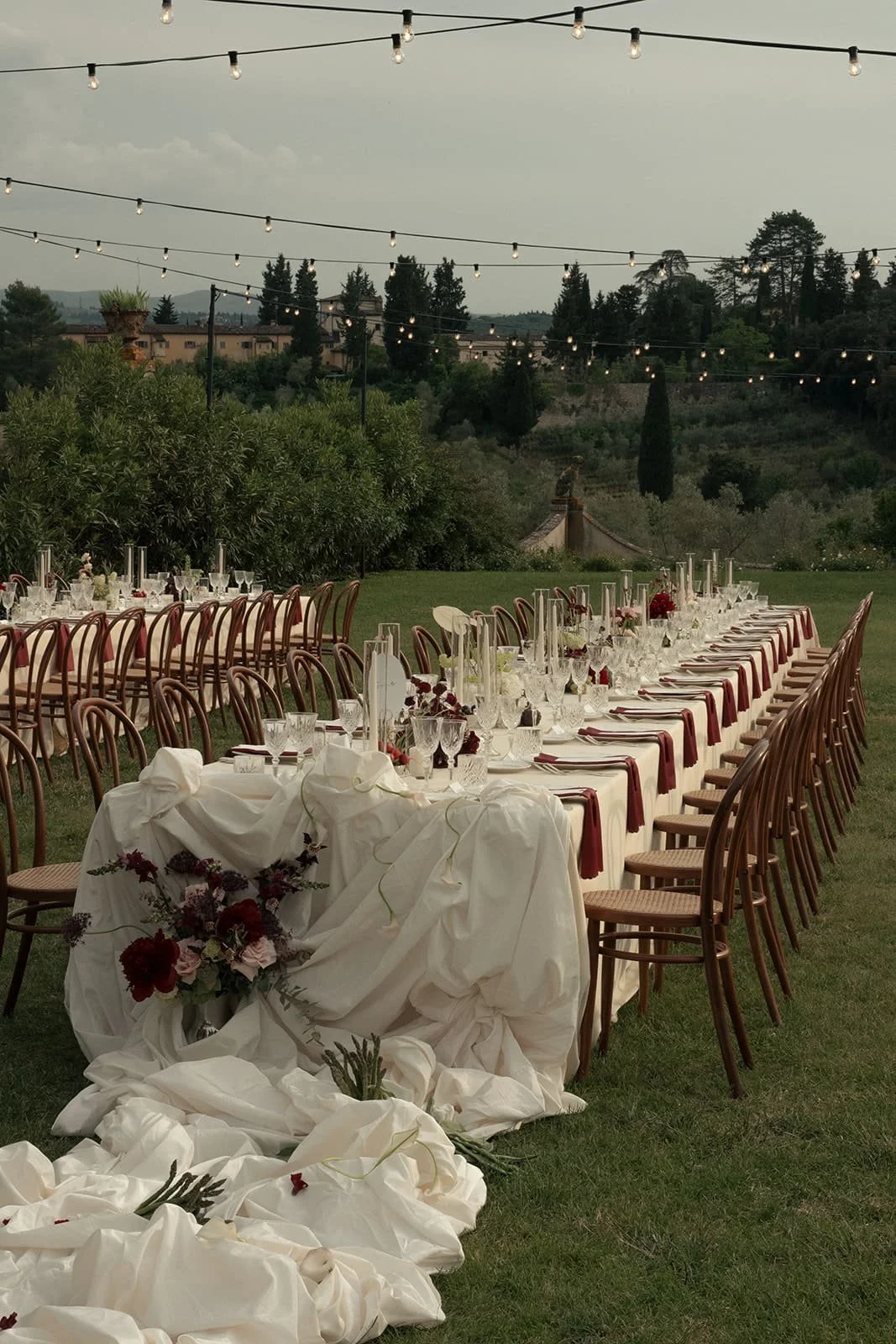Luxury wedding dinner styling with a dramatic draped central table