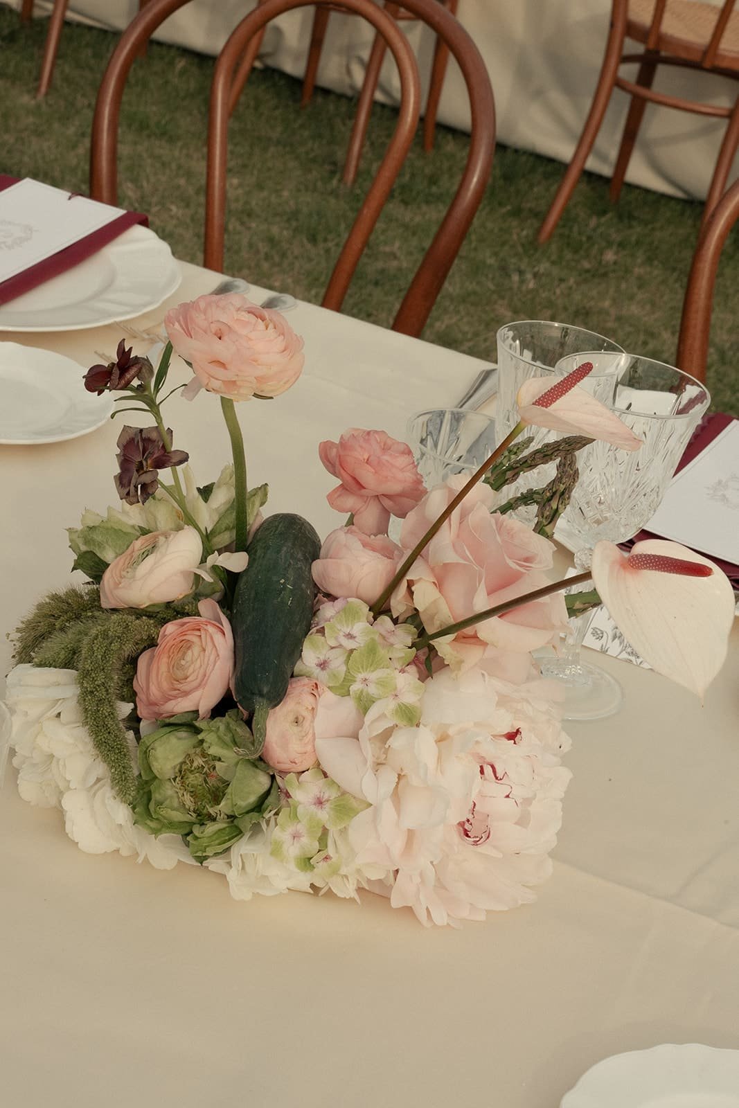 White, green and soft pink flower composition with cucumbers 