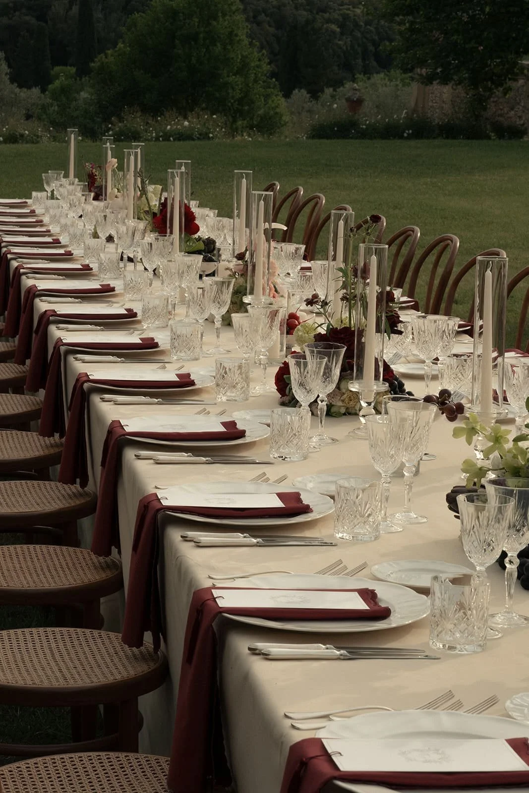 ophisticated Tuscan wedding tablescape with burgundy flowers and seasonal produce