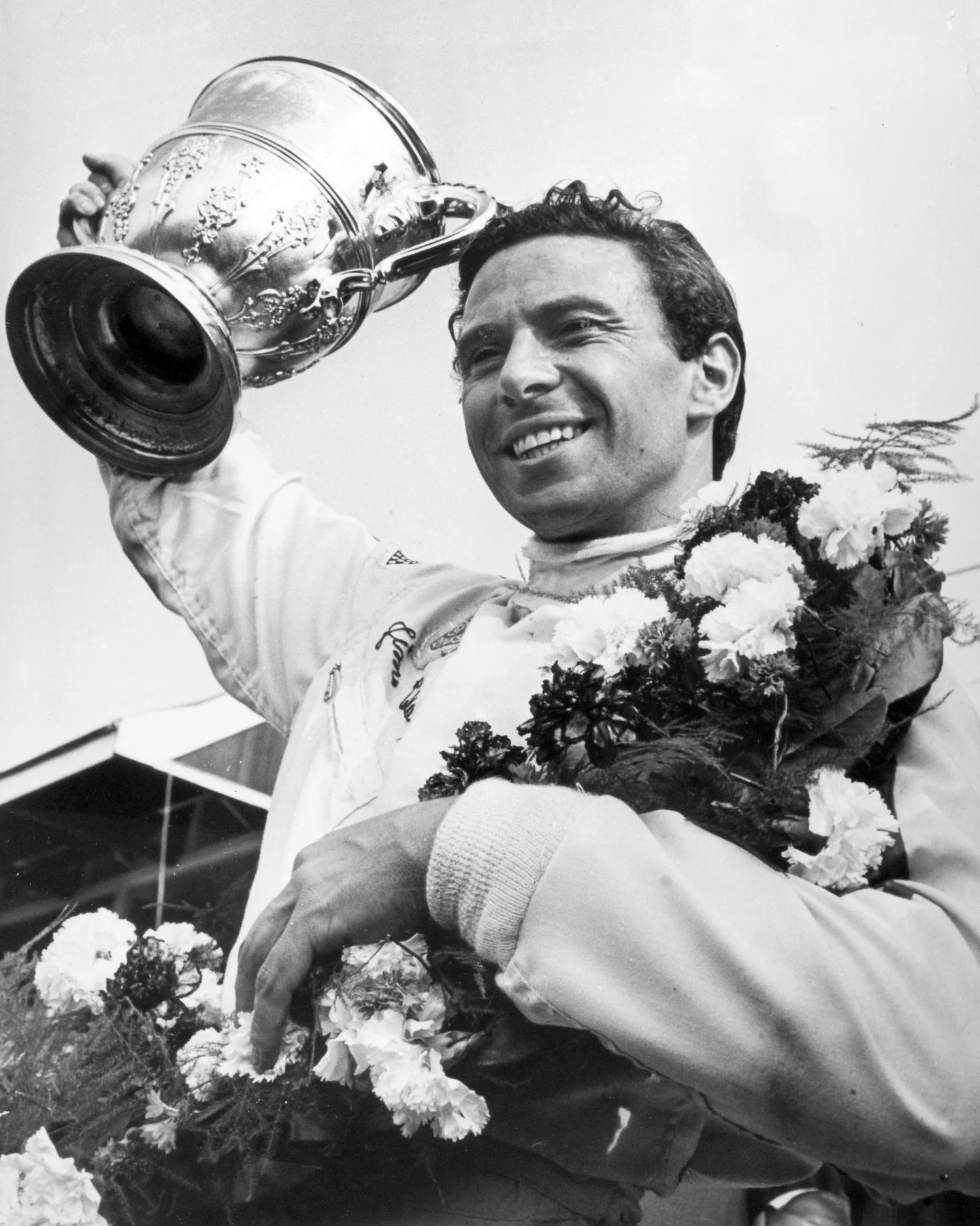 British Grand Prix at Silverstone: Great Britain's Jim Clark (1926 - 1968) celebrates with the trophy after winning the race in 15th July, 1967. Jim Clark, a Scot, was World Champion twice in 1963 and 1965.

 #photography #formulaone #jimclark #sport