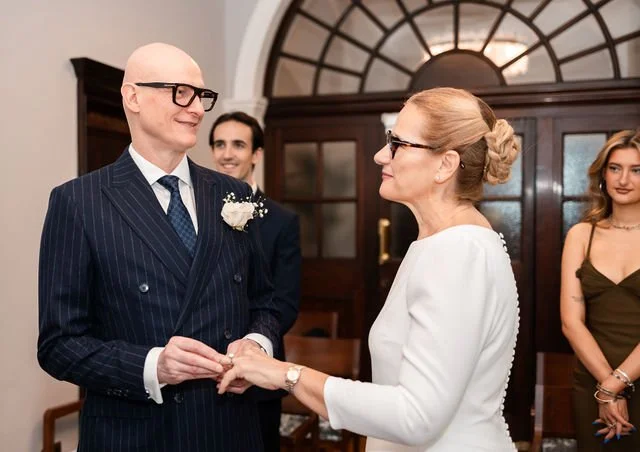Bride and groom exchanging vows during a civil ceremony at Chelsea Town Hall.jpg