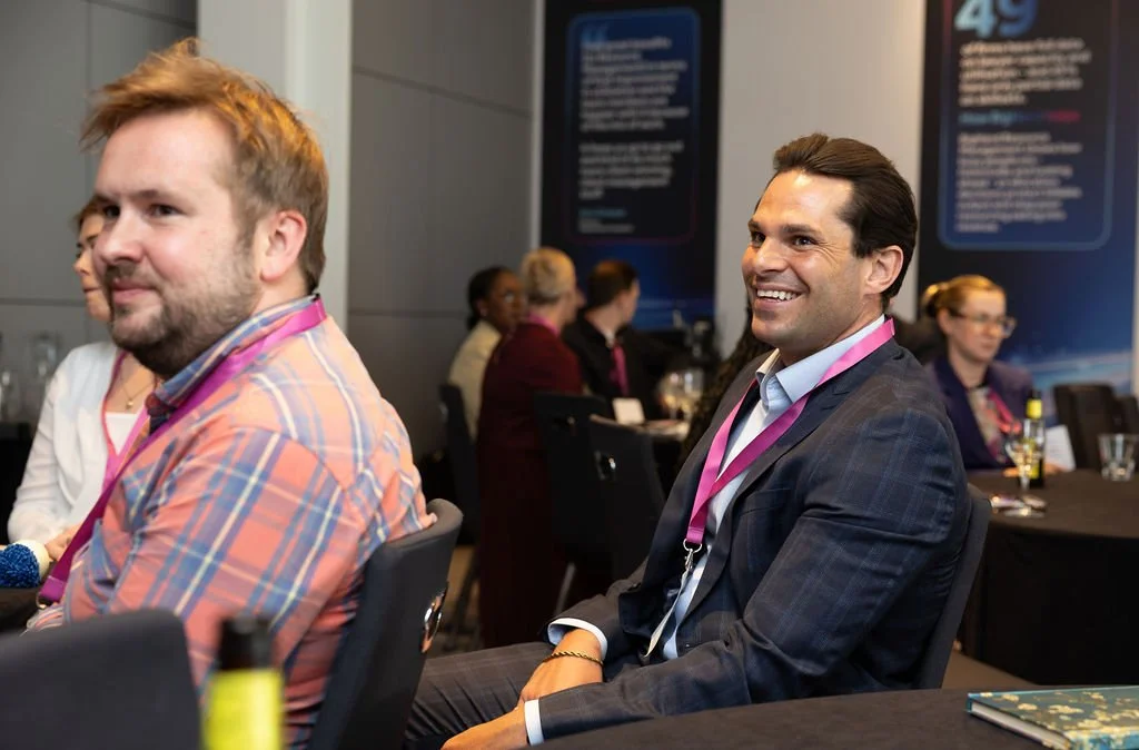 two men smiling during corporate event