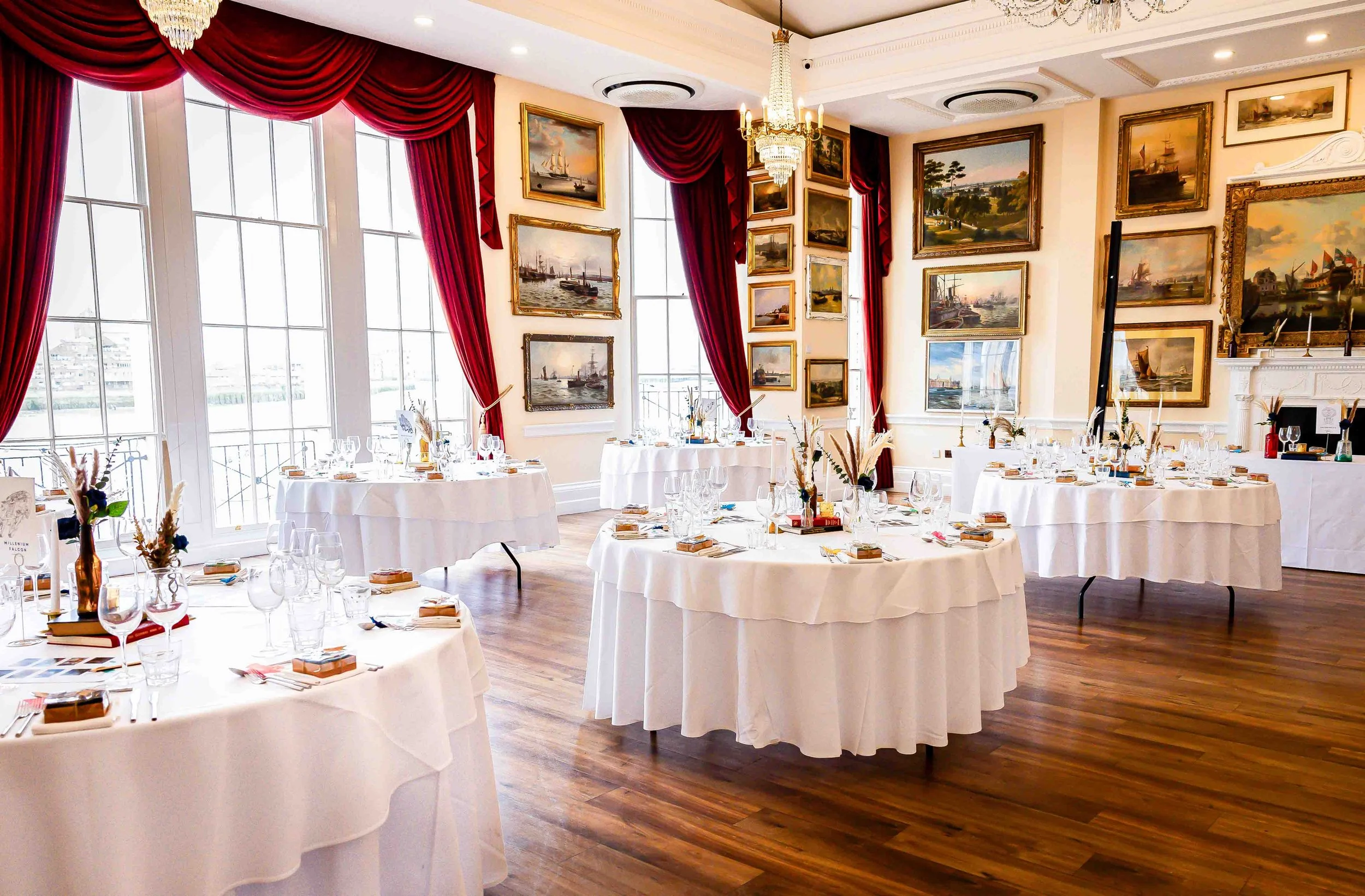 Round reception tables inside Trafalgar Tavern wedding room