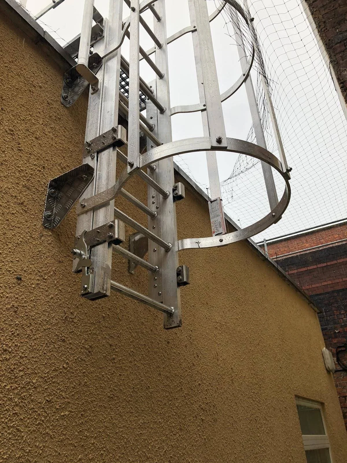Caged Ladders | Fixed Access Ladders with Safety Cages — ALTUS