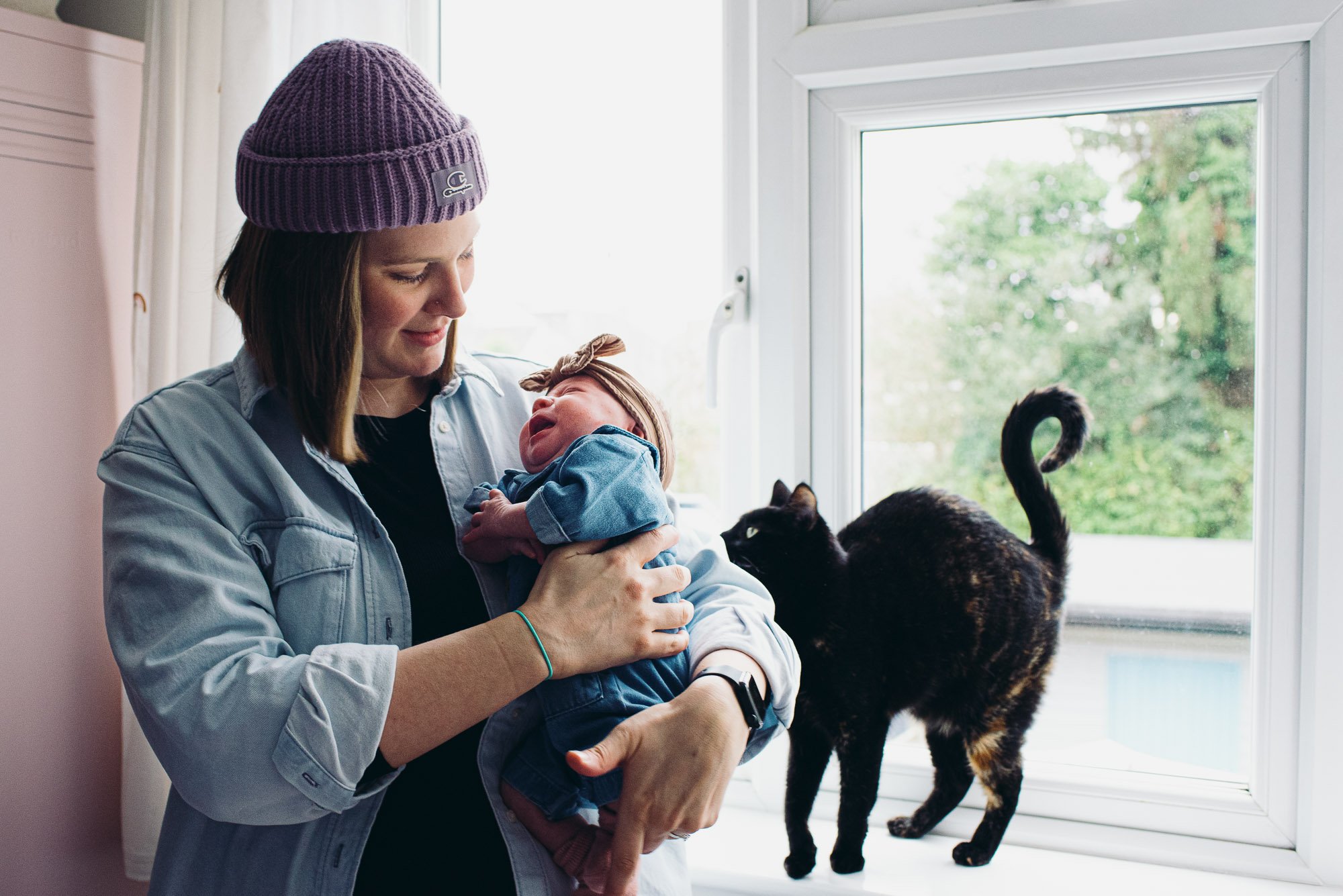 newborn-photography-at-home-brighton-hove-sussex-mother-baby-girl-cat-window.jpg